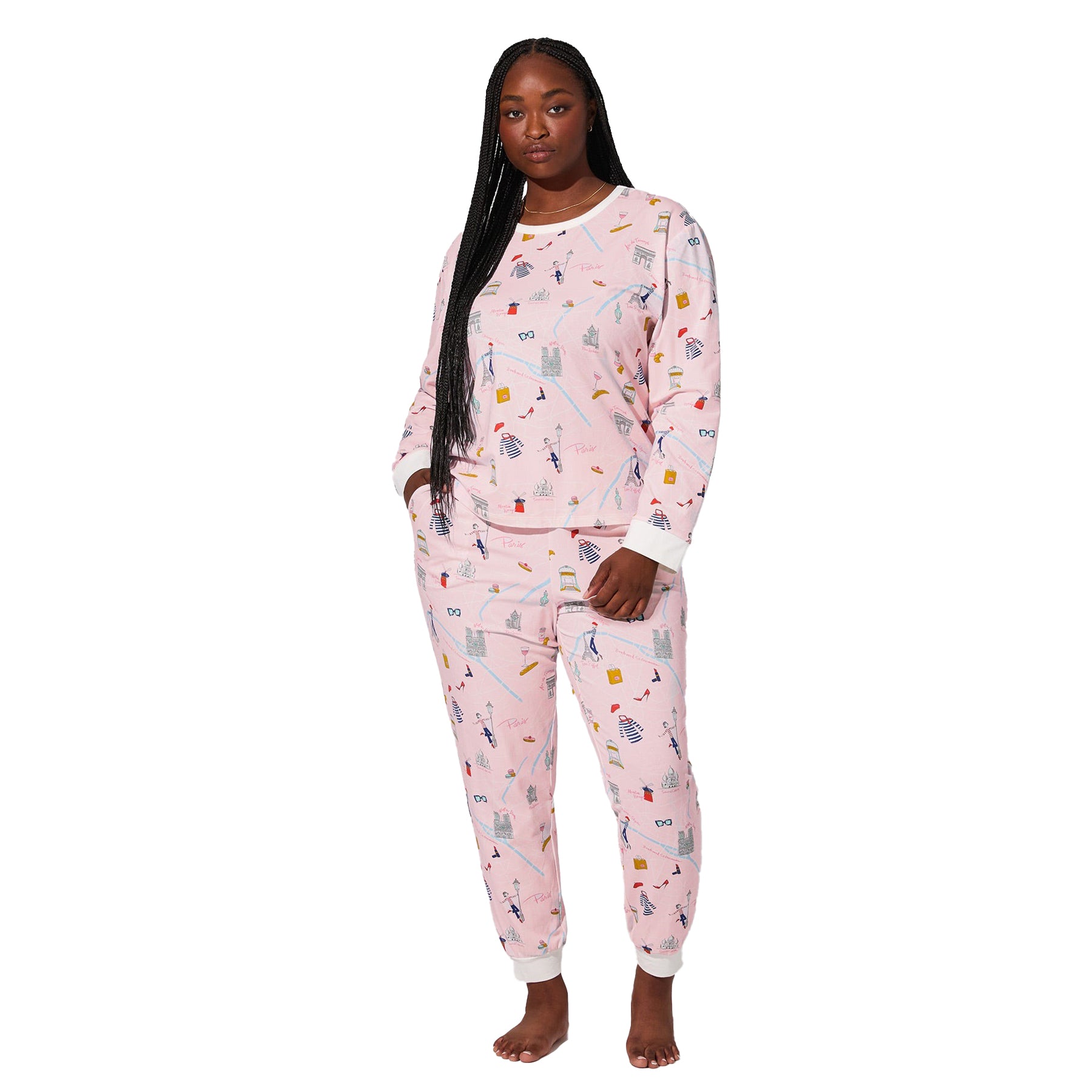 Front view of plus-size model wearing blush pink Paris print pajama set with long sleeves and tapered pants.