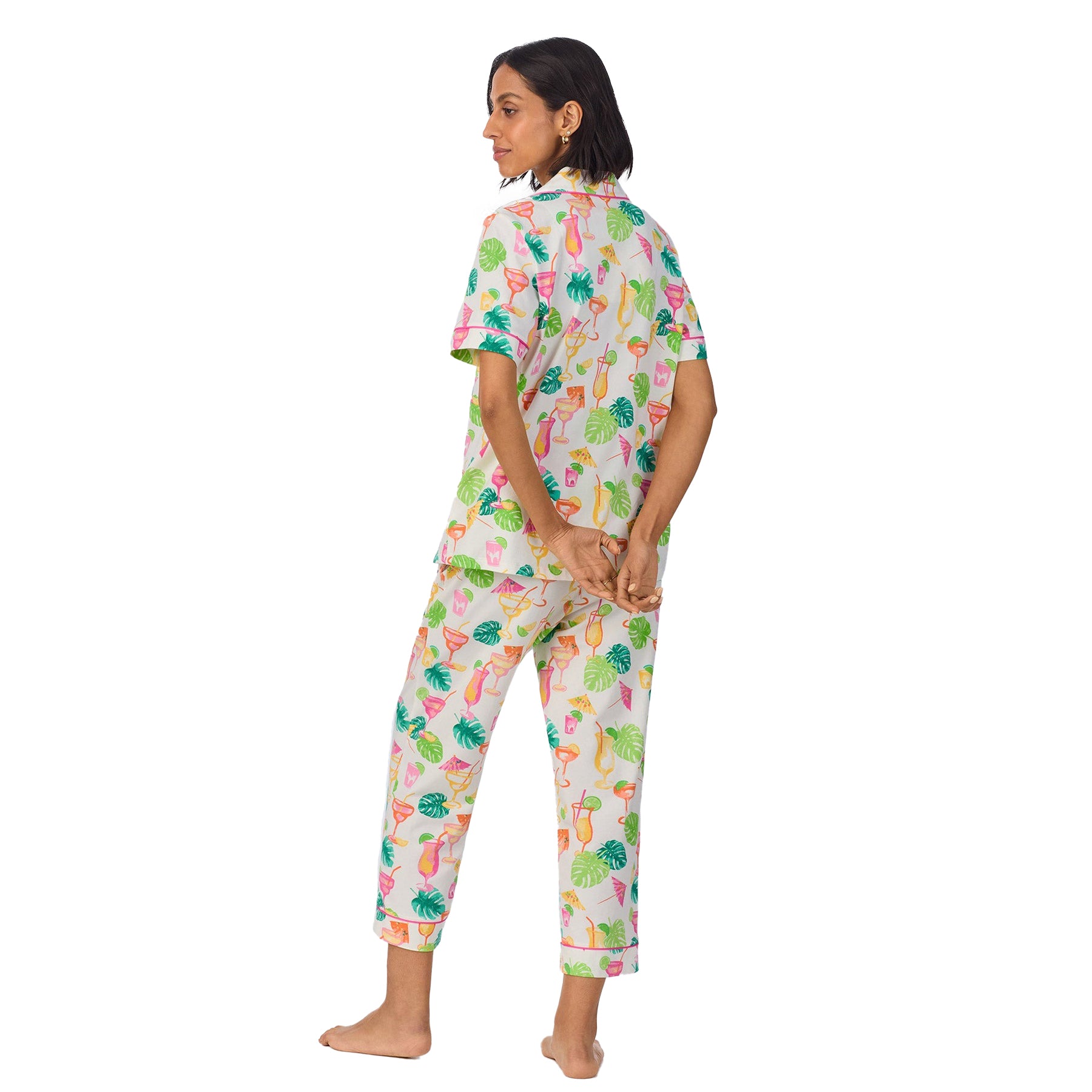 Model showing the back of the tropical cocktail print pyjama set with hands behind her back.