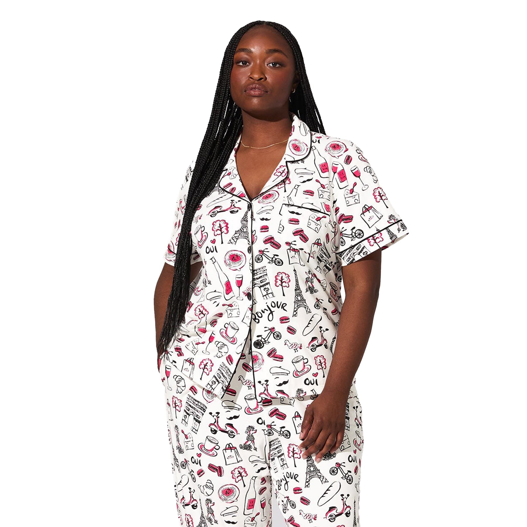 Front view of plus-size model wearing white Paris print pajama set with black piping and button-front short-sleeve top.