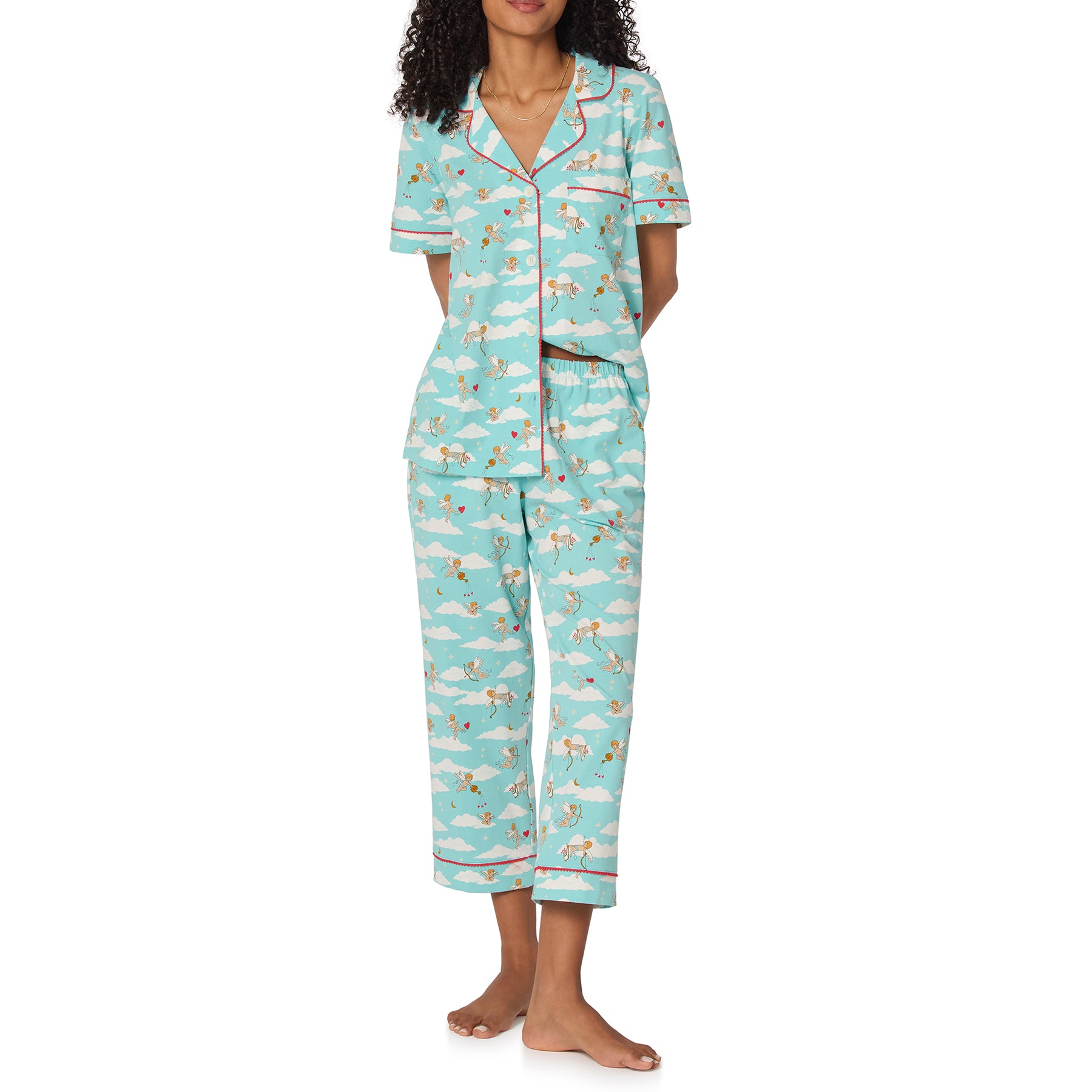 Woman wearing a light blue pajama set with animal pattern on a white background