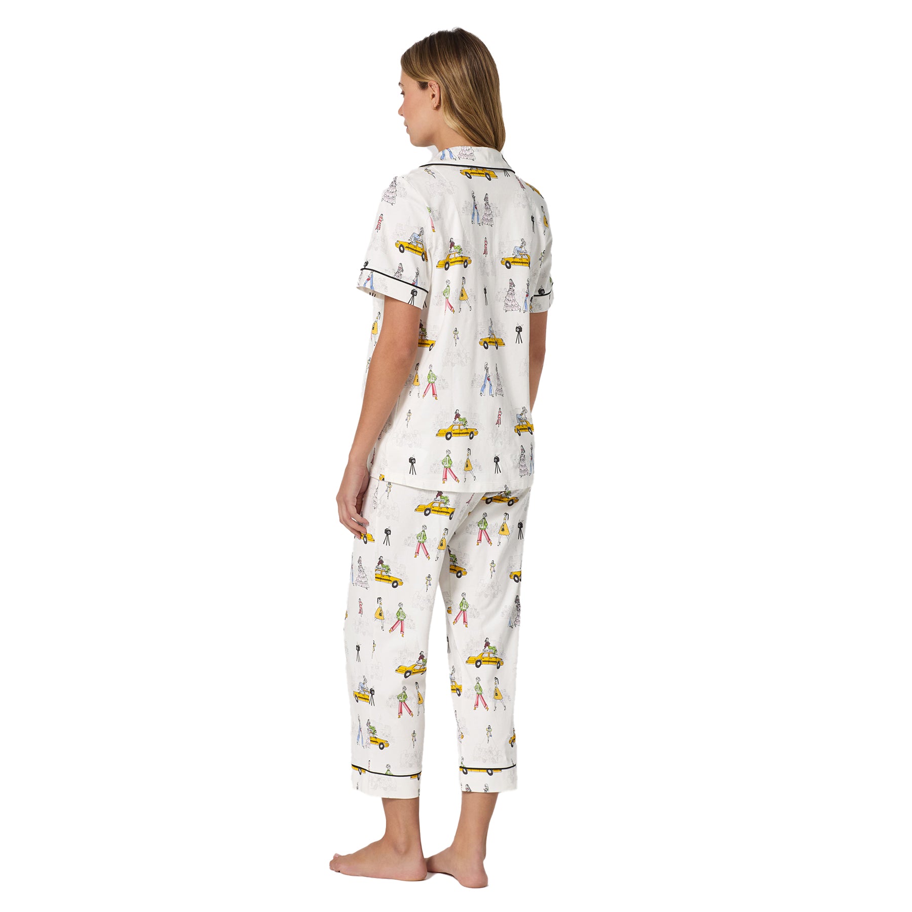 Back view of the short sleeve pyjama top and matching pants highlighting the all-over fashion illustration print.