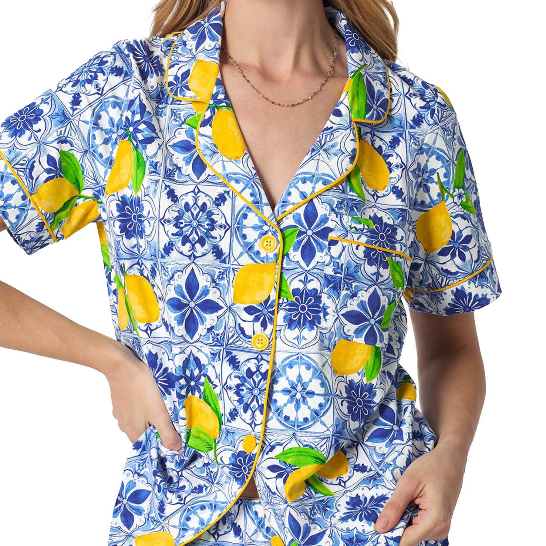 Close-up of Bedhead pajama top featuring blue tile print, yellow lemons, contrast piping, and button-front styling.
