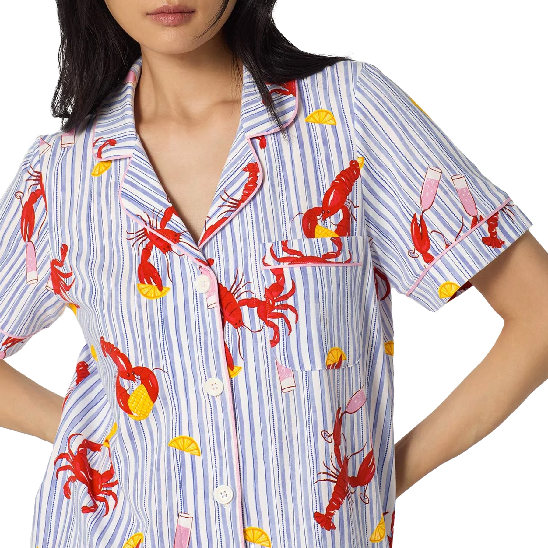 Close-up of a blue and white striped pyjama top with red lobster print, pink piping detail, chest pocket, and button-front closure.