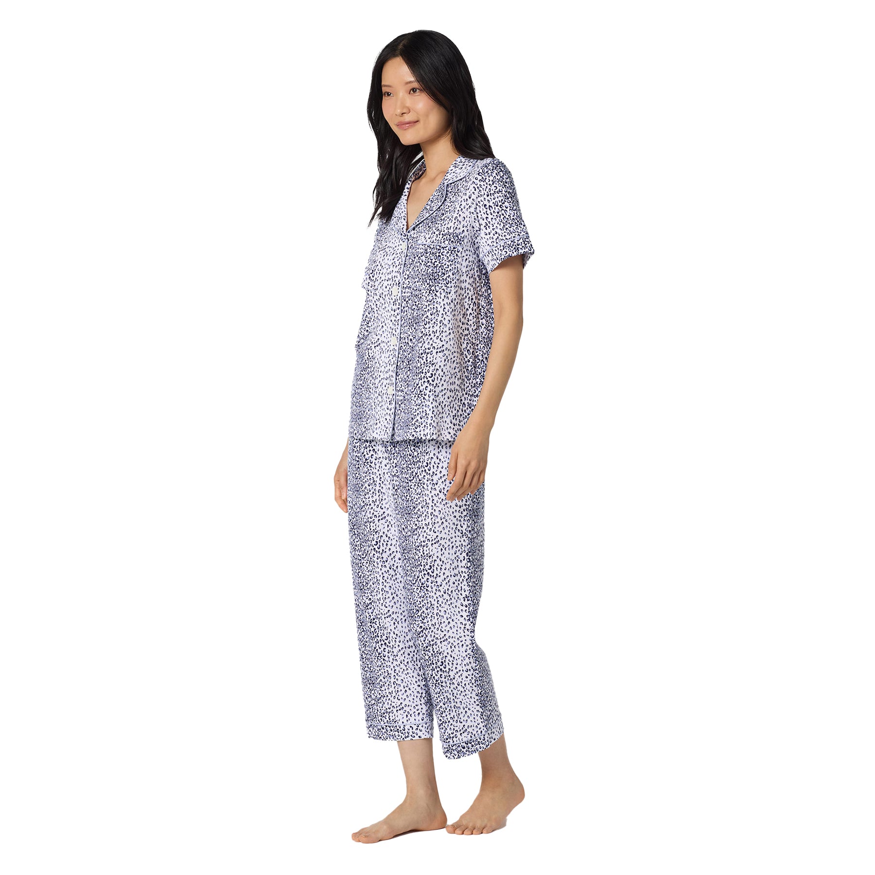 Side view of a lightweight leopard print sleepwear set with short sleeves, classic collar, and cropped straight-leg pants.