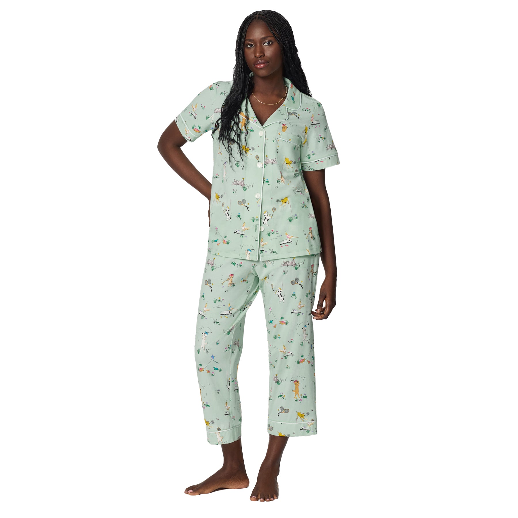 Full-length view of mint green cotton pajama set with short sleeve button-front shirt and cropped pants in whimsical dog sport print.