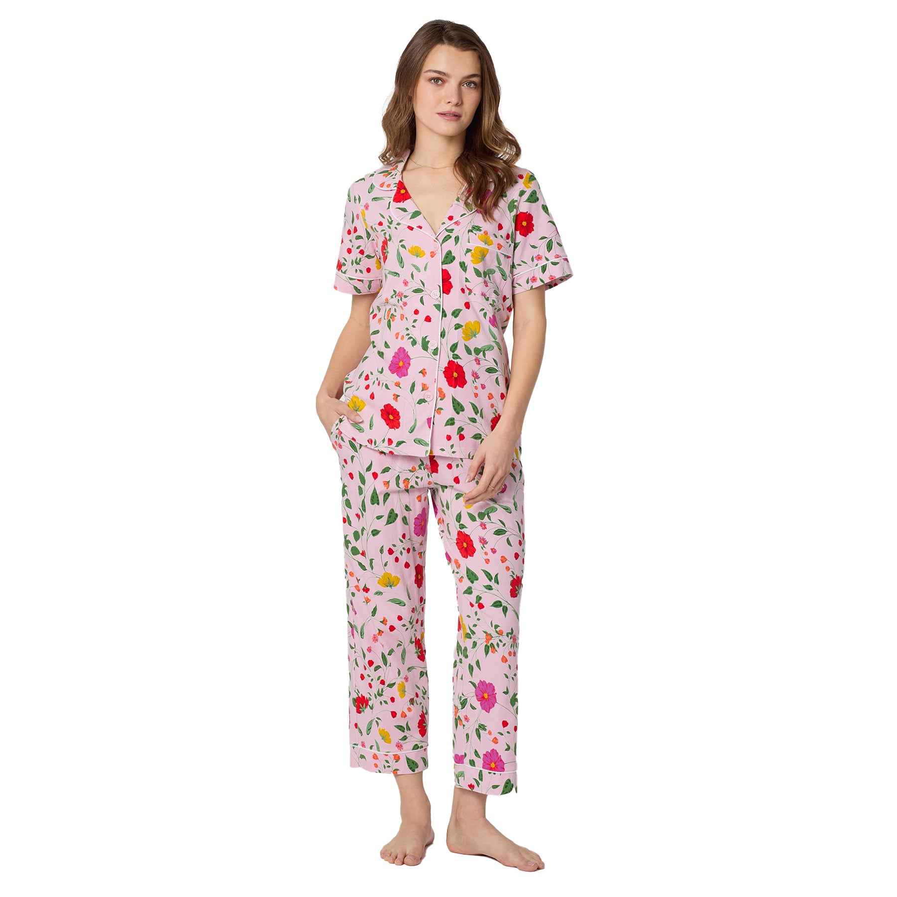 Full-length view of women’s pink floral pajama set with short sleeve button-front shirt and cropped pants in colourful botanical print.