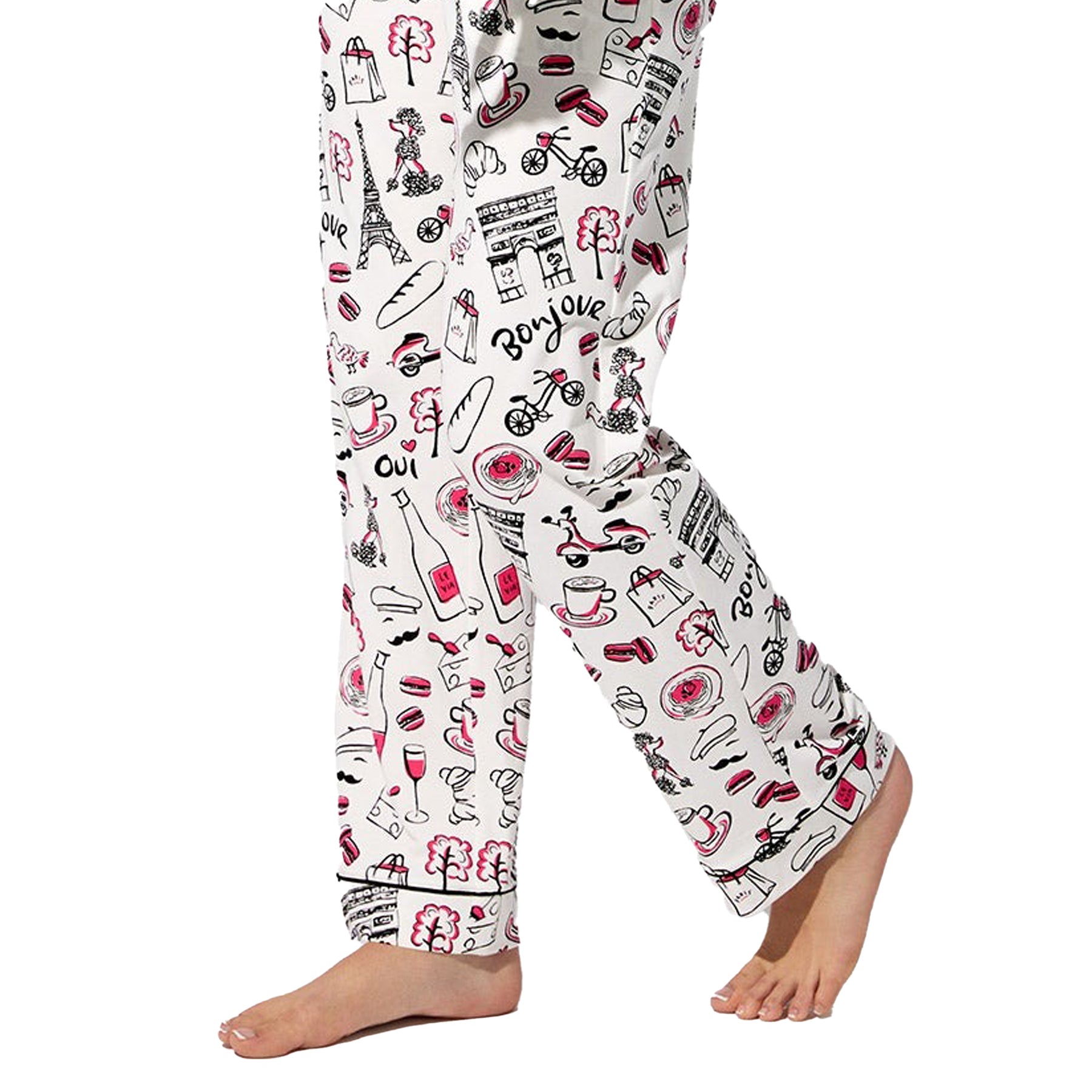 Close-up of Paris-themed print on white pyjama pants with black piping hem