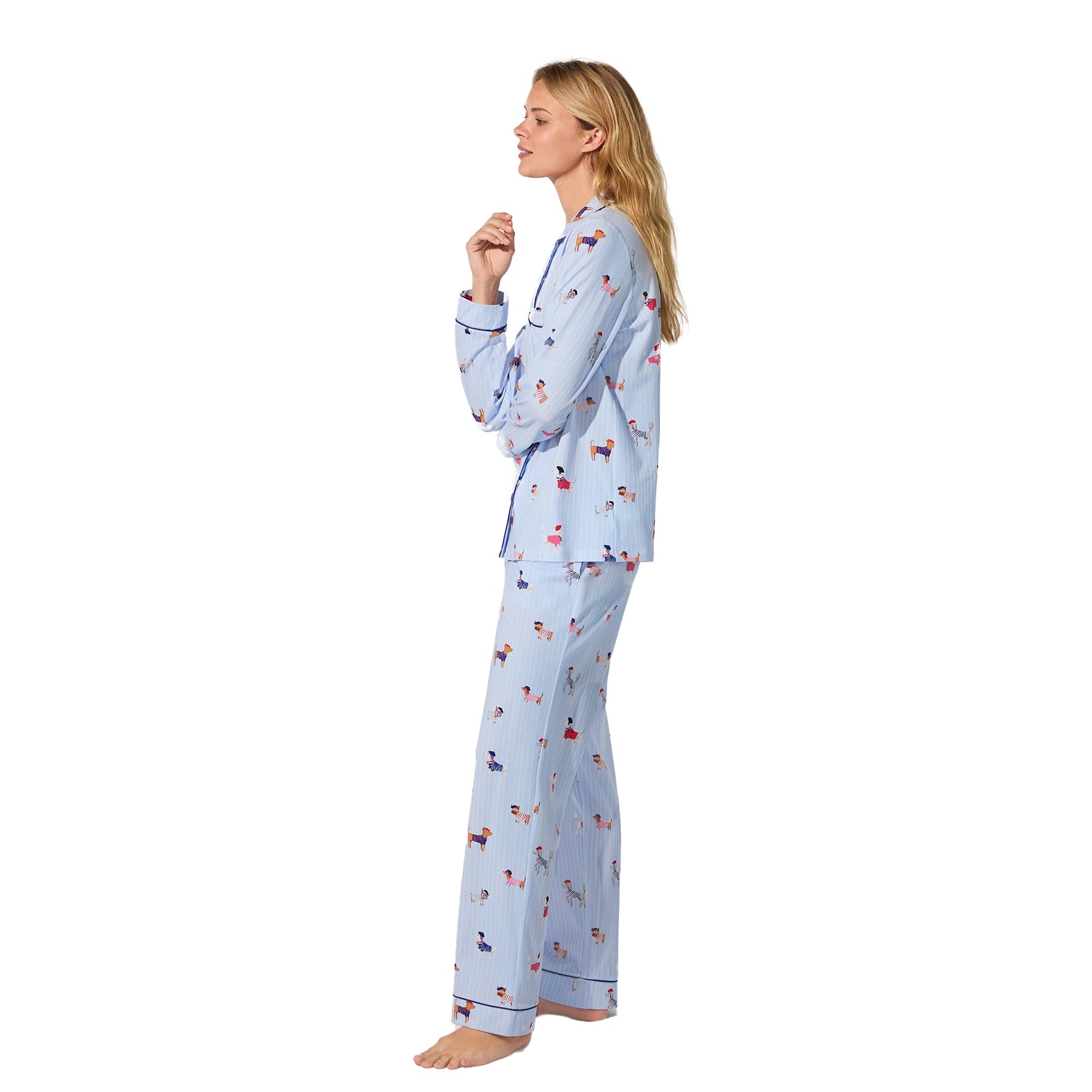 Side view of model wearing light blue dog-print pyjama set with navy piping
