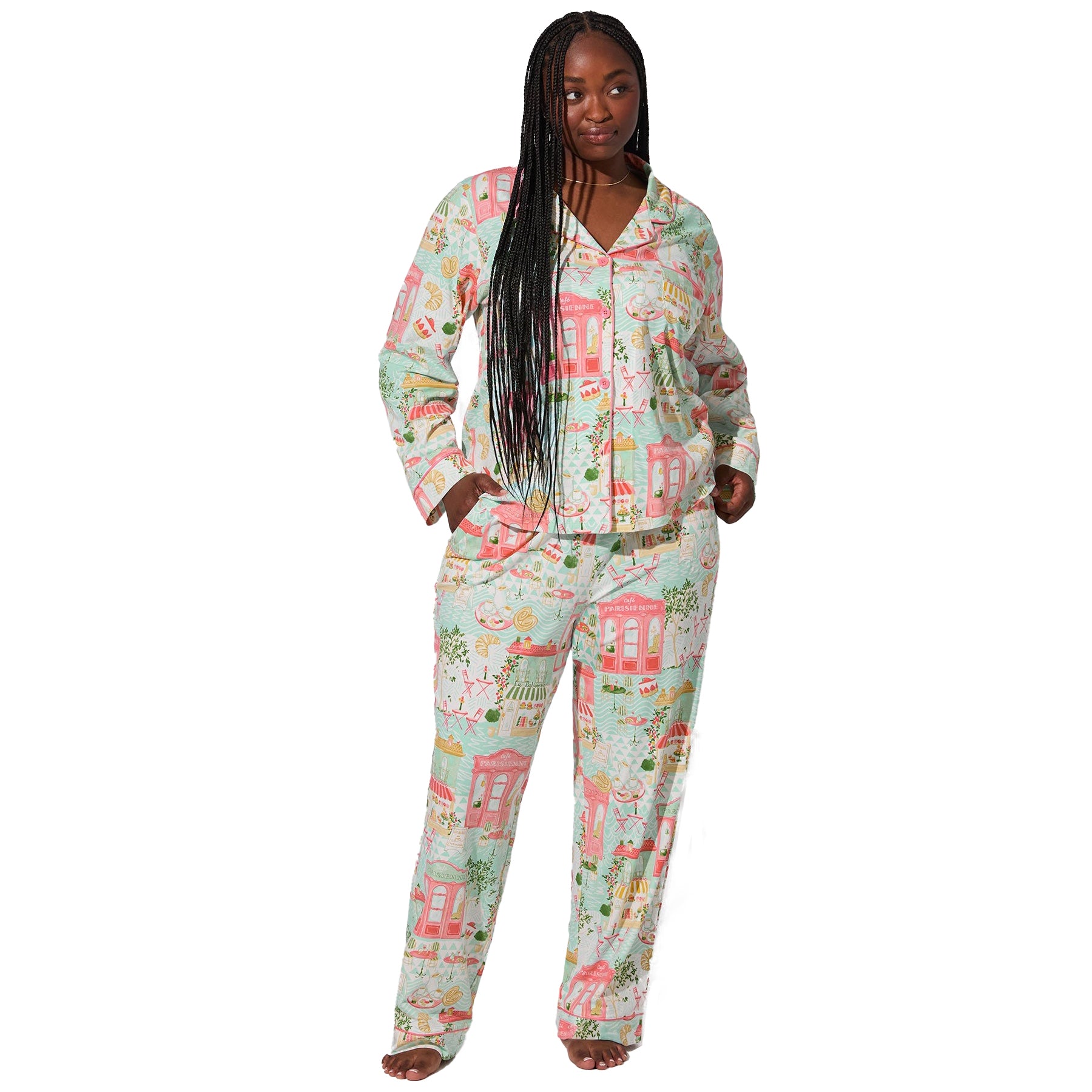 Front view of plus-size model wearing light aqua Paris-themed pyjama set with pink piping