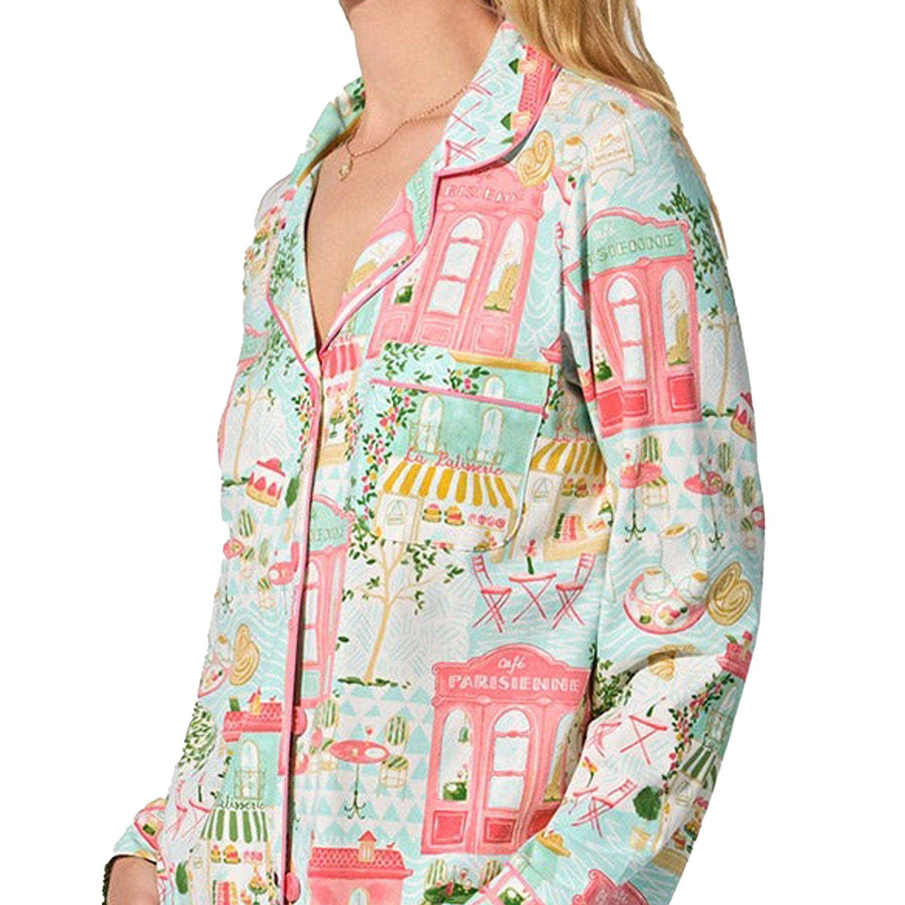 Close-up of Parisian café and bakery print on light aqua pyjama top with pink piping