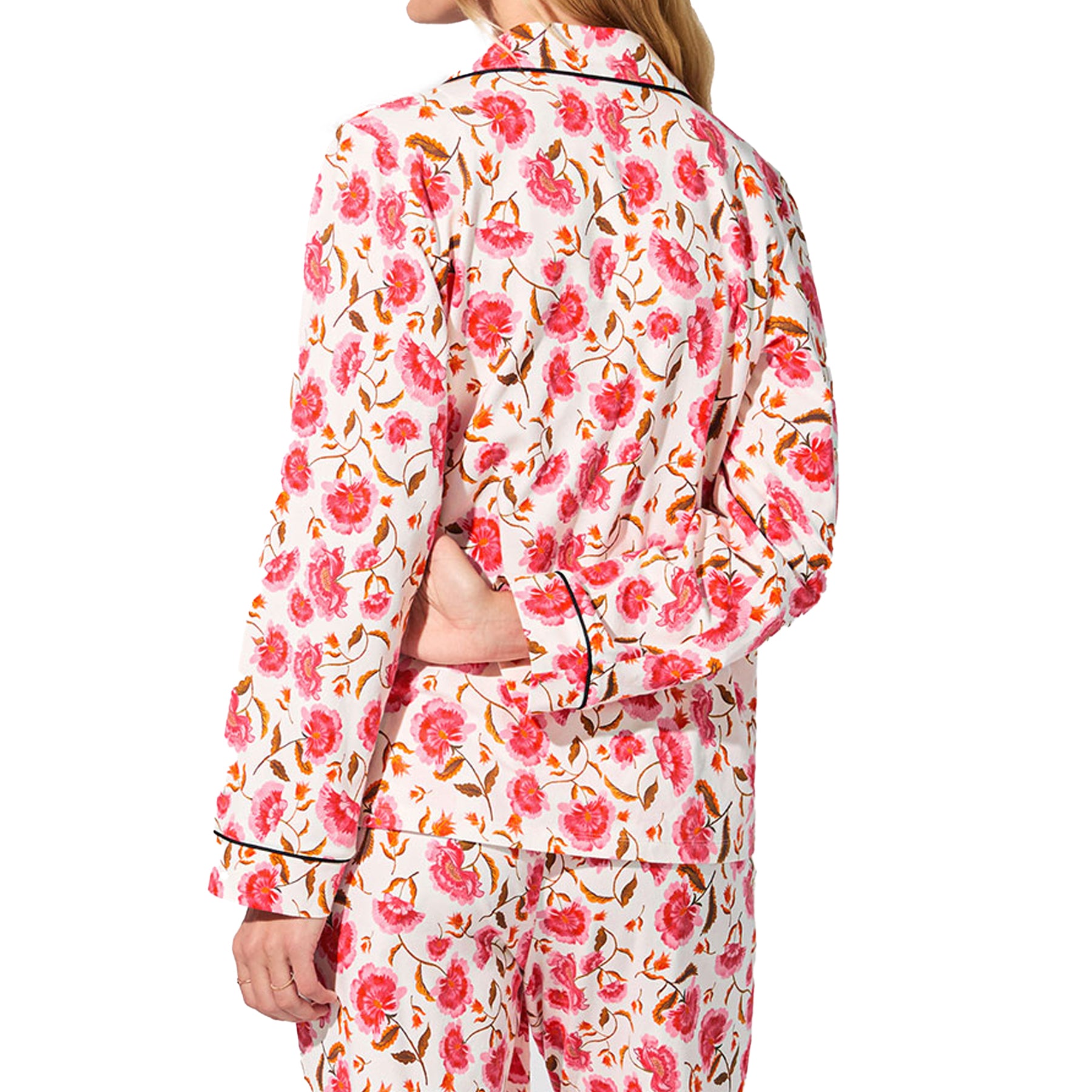 Back view of white floral pyjama shirt and pants with all-over pink and orange floral print.