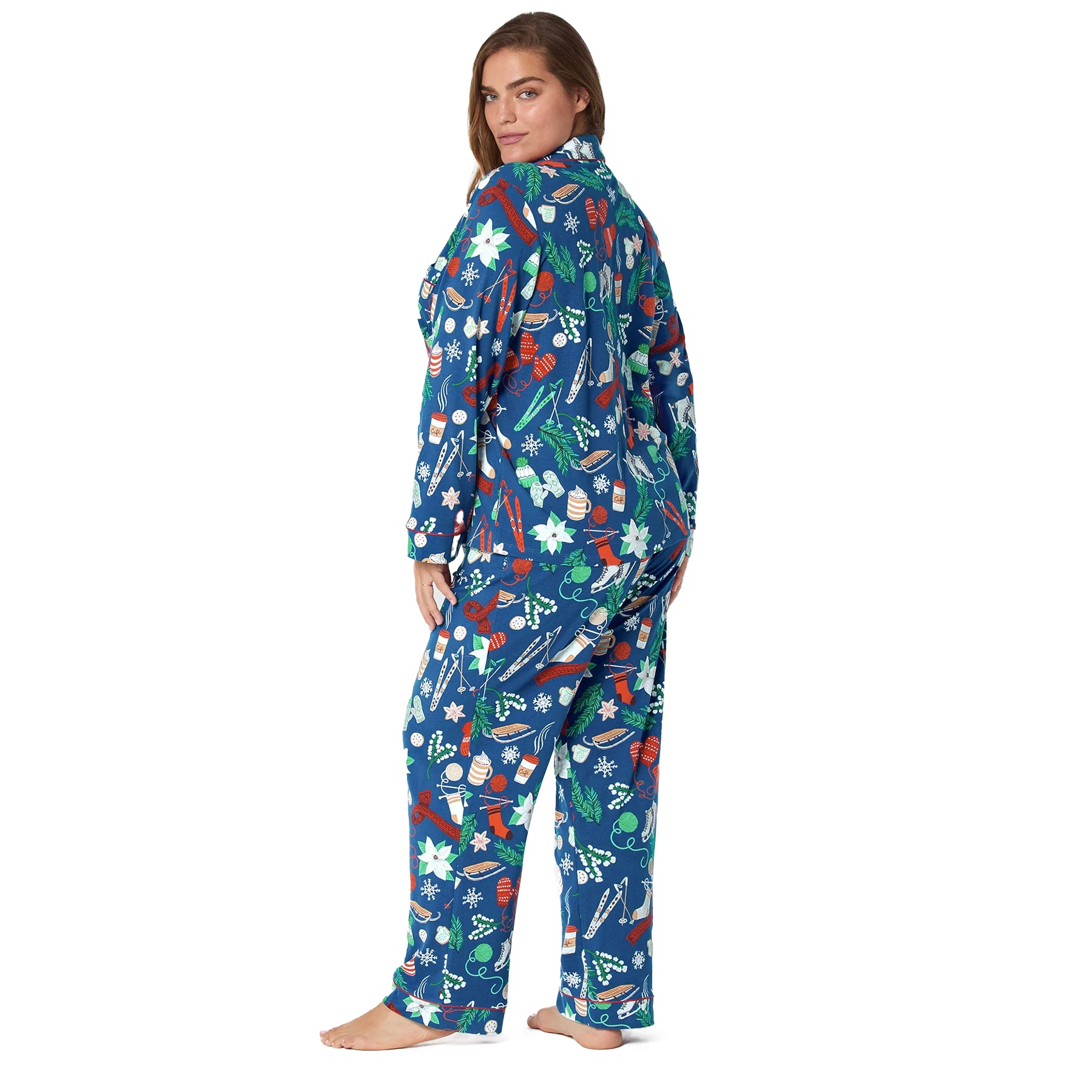 Plus-size model wearing navy festive pyjama set with holiday print, back angle view.