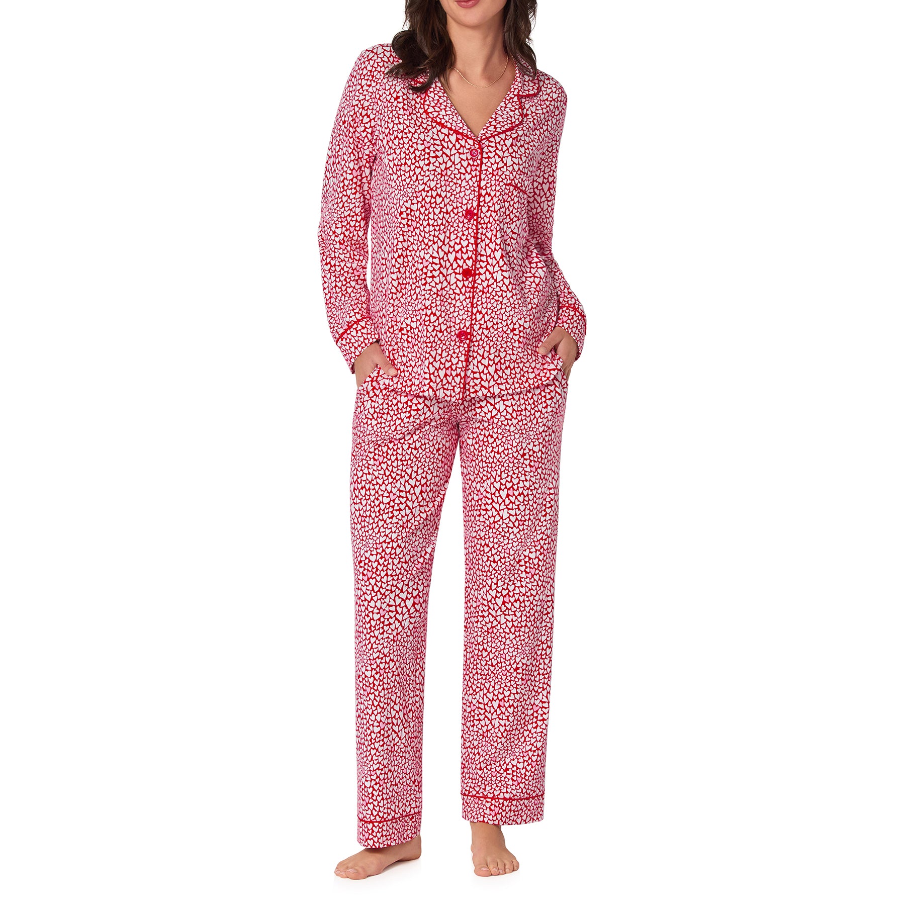 Woman wearing a red and white patterned pajama set on a white background