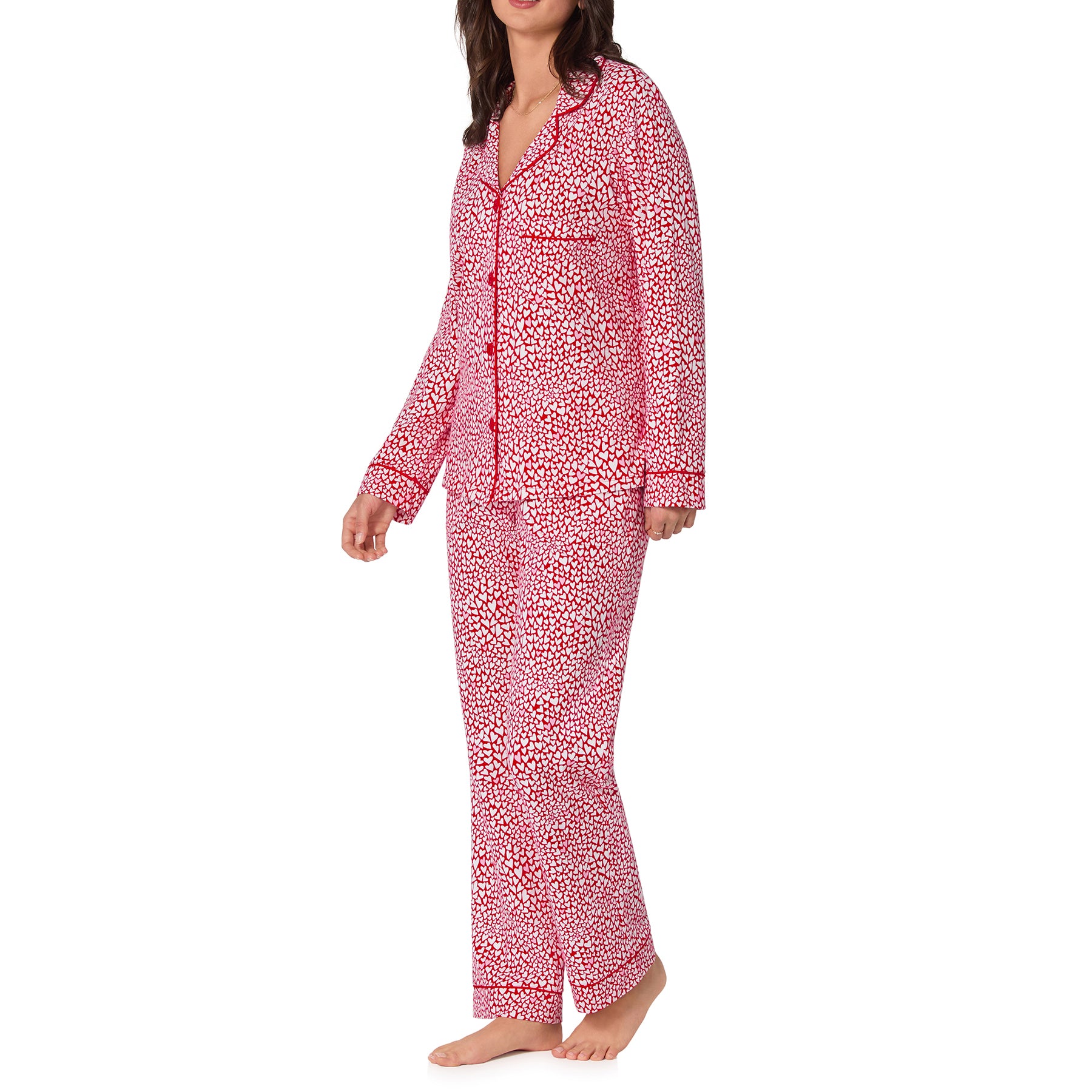 Woman wearing a red and white patterned pajama set on a white background
