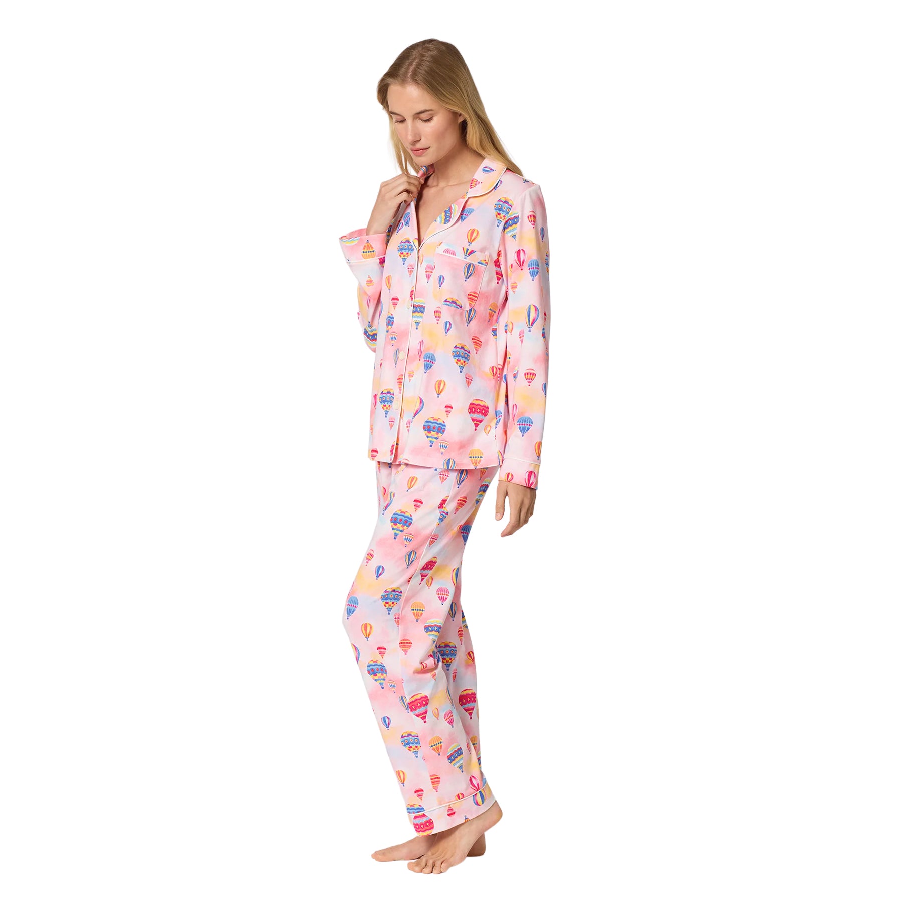Side view of a pink long-sleeve pajama set featuring a colourful hot air balloon print, chest pocket and full-length pants.
