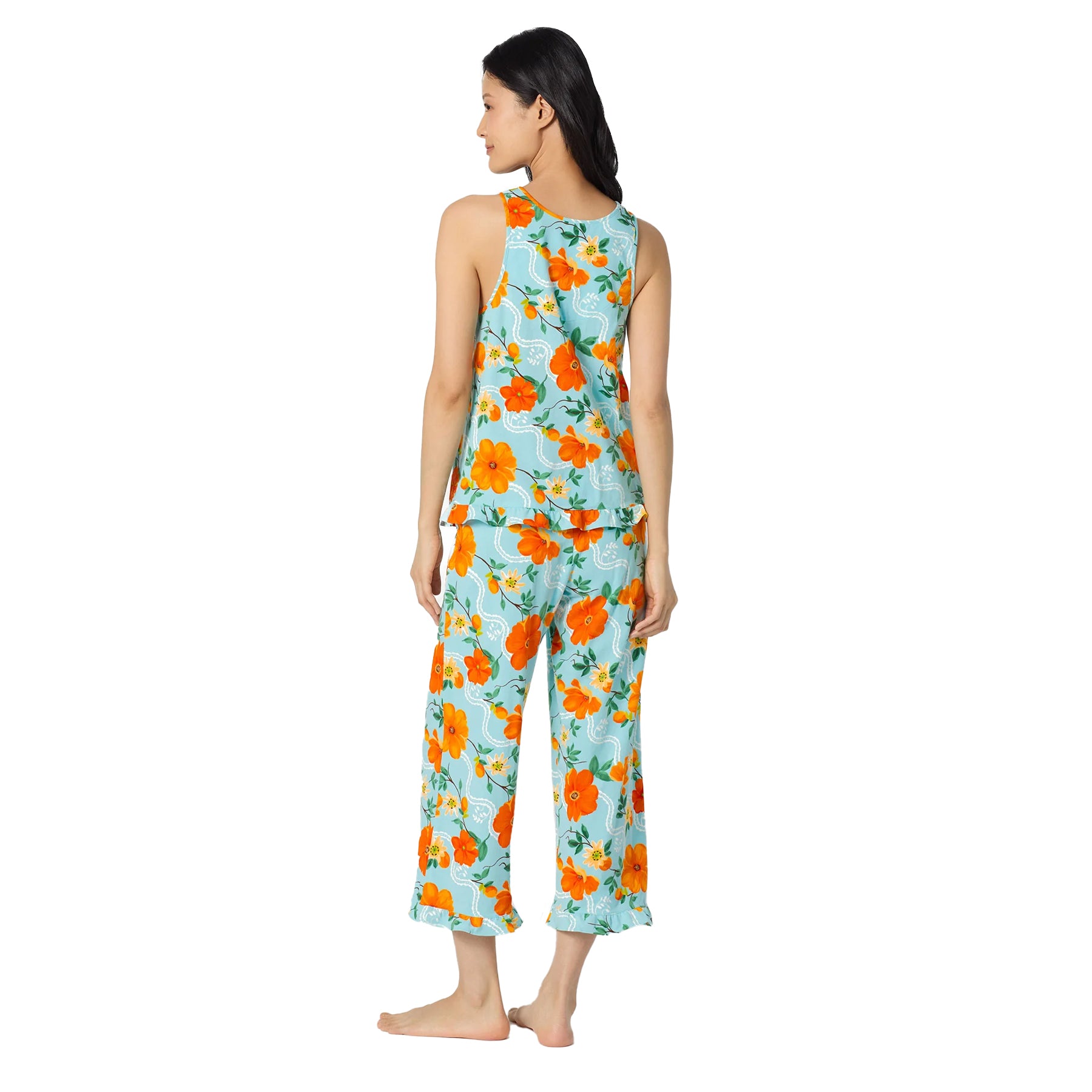 Side back view of an aqua blue floral pyjama set with bold orange flowers, relaxed sleeveless top, and cropped wide-leg pants for lightweight comfort.