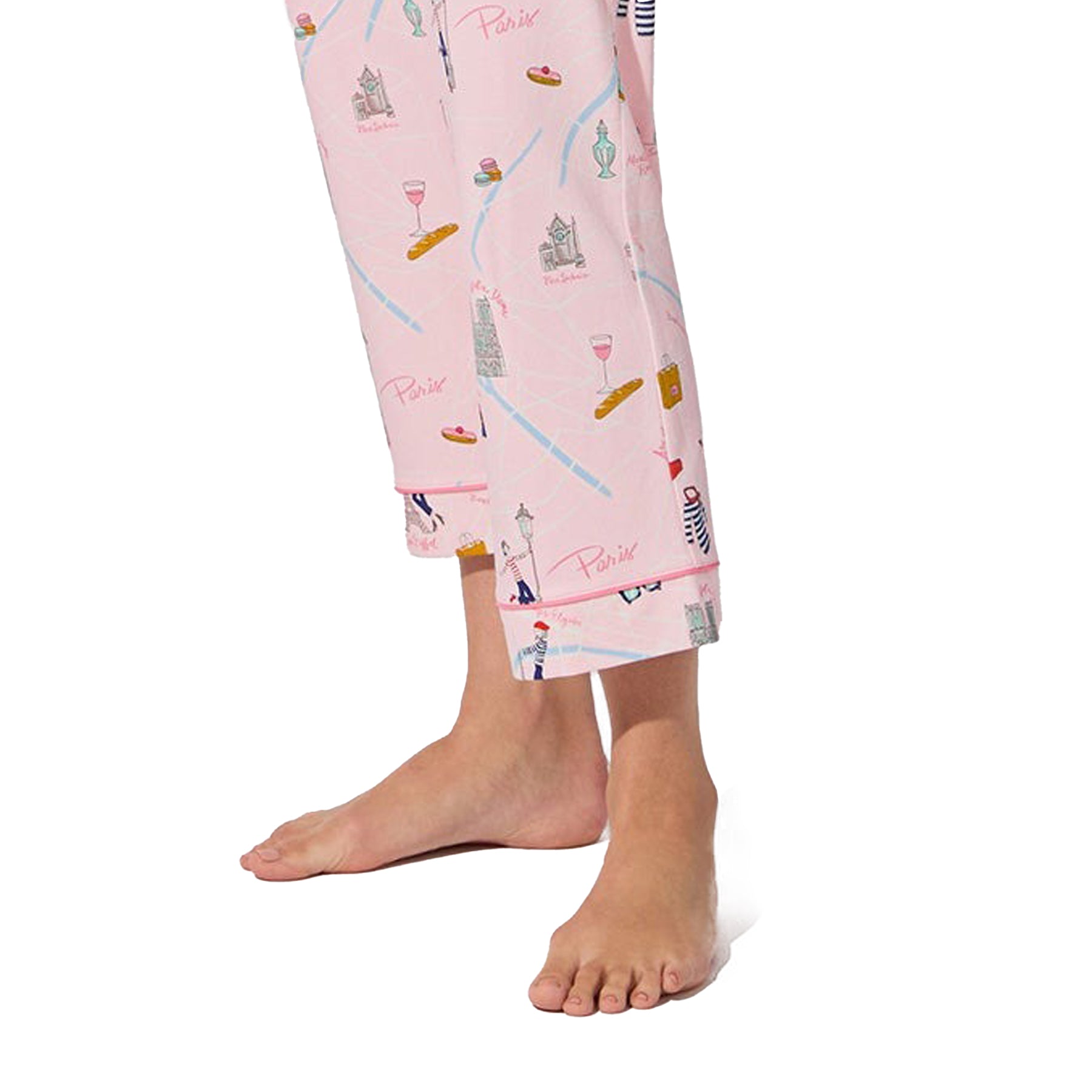 Close-up of cropped pant legs in blush pink with Paris print and pink piping at hem.