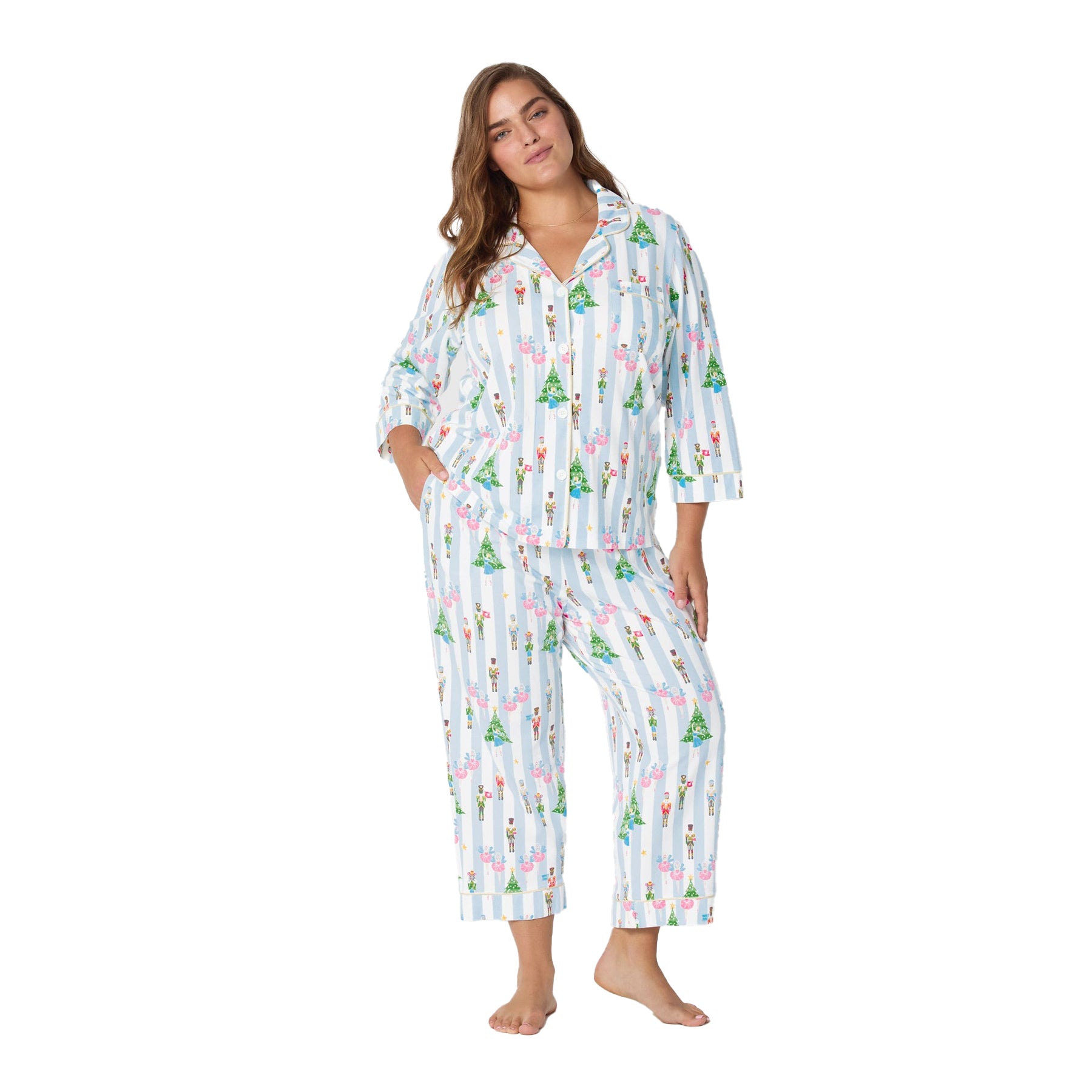 Woman wearing a festive pajama set with a white background