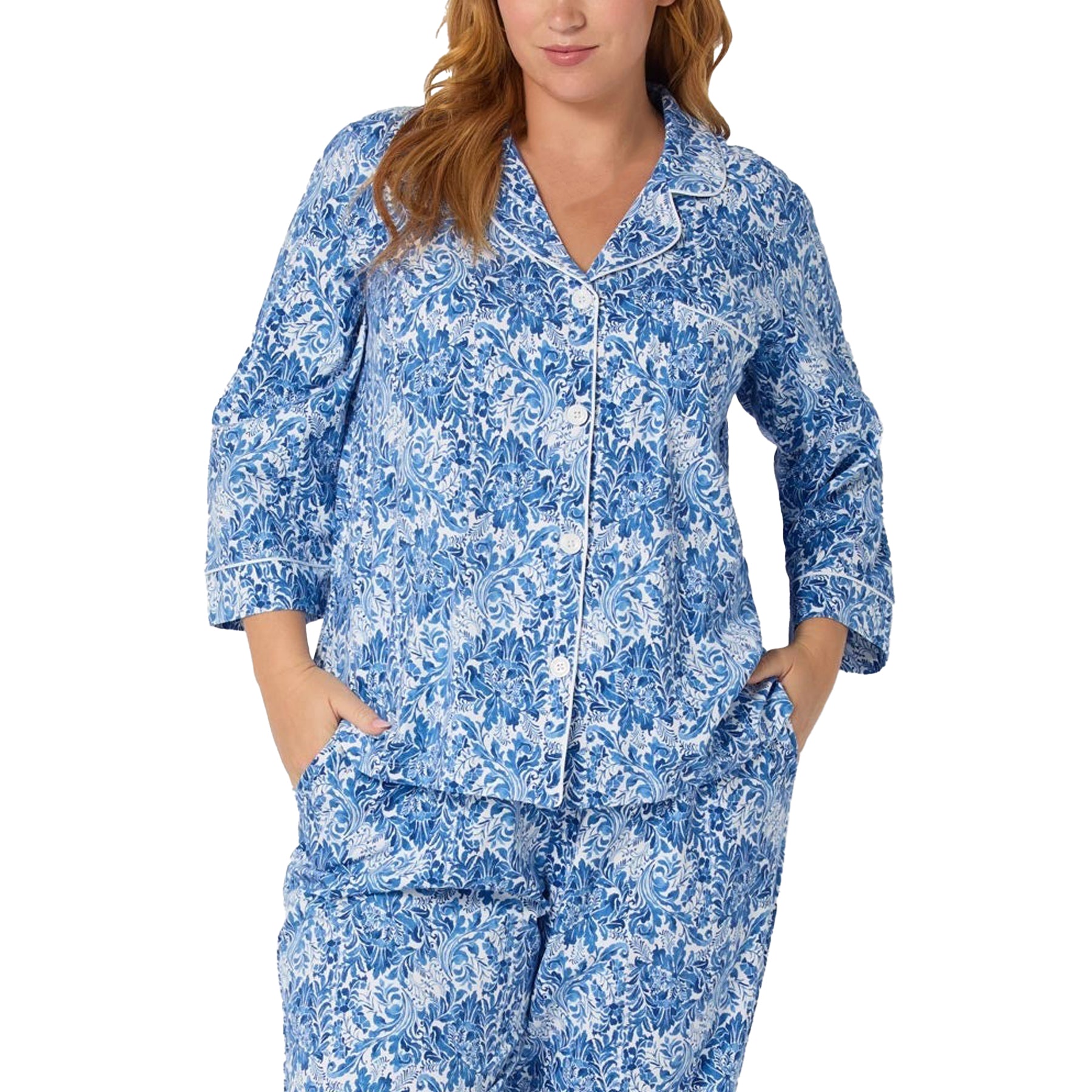 Woman wearing a blue floral pajama set on a white background