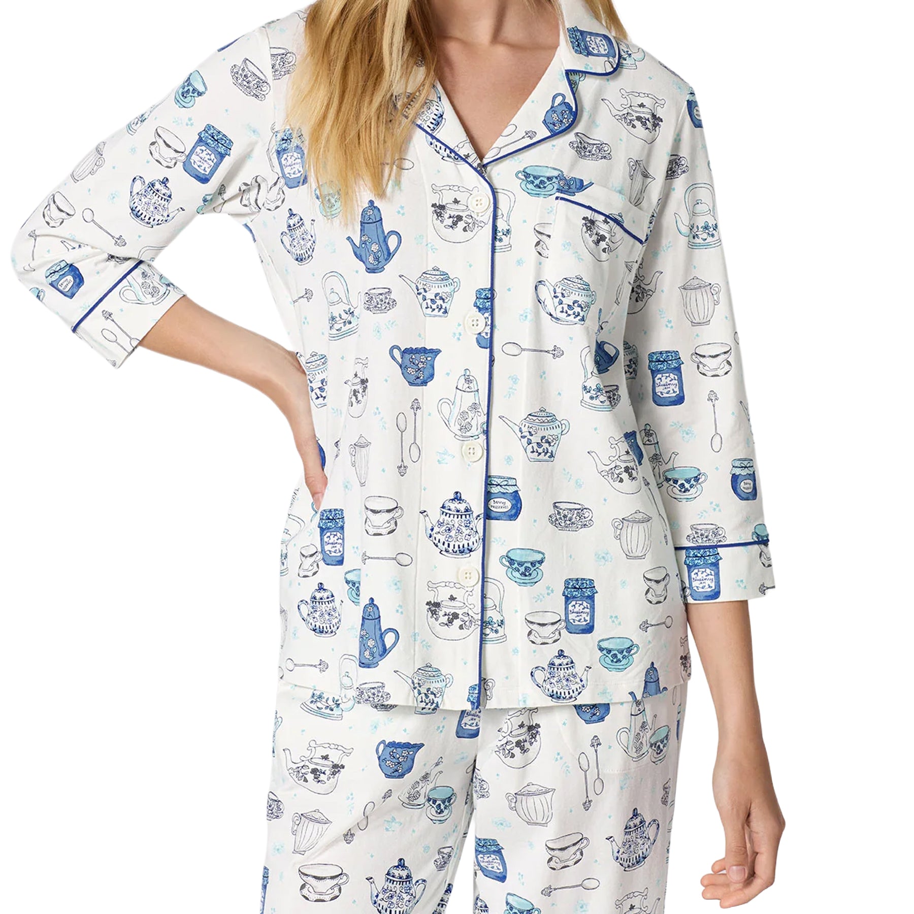 Close-up of BedHead white pajama set with blue teapot and teacup print, button-front top, chest pocket and contrast piping.