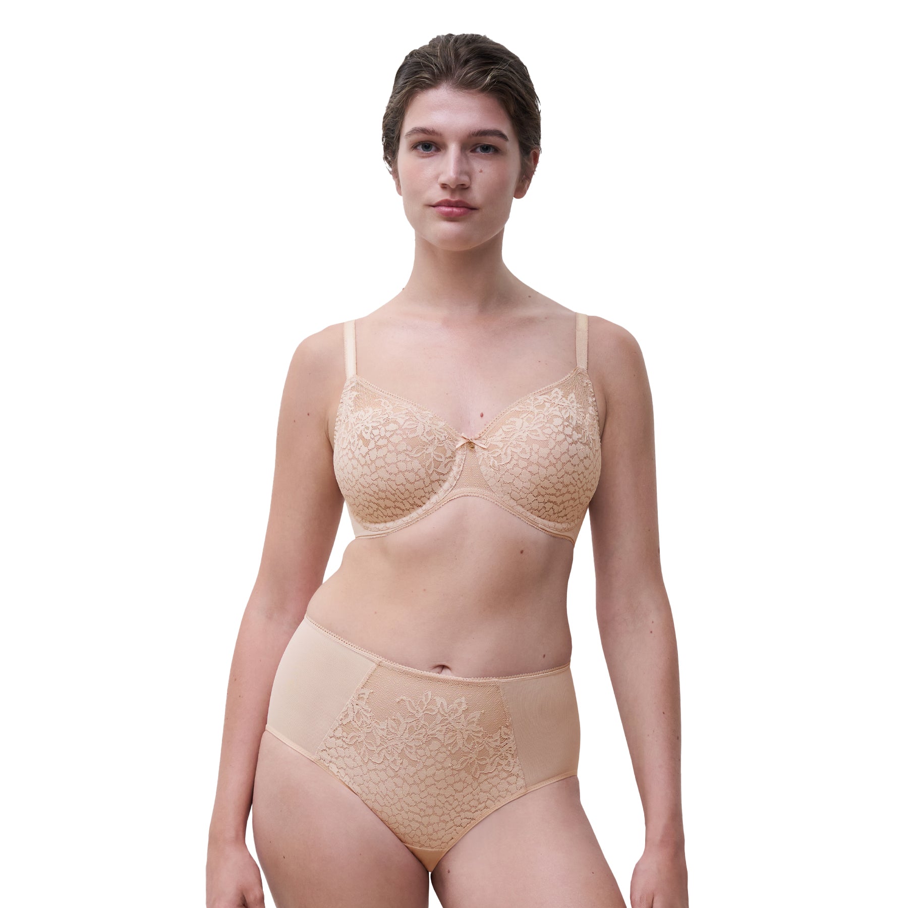 Model wearing Chantelle lace bra and high-waist brief set in peau rosée, full body front view.