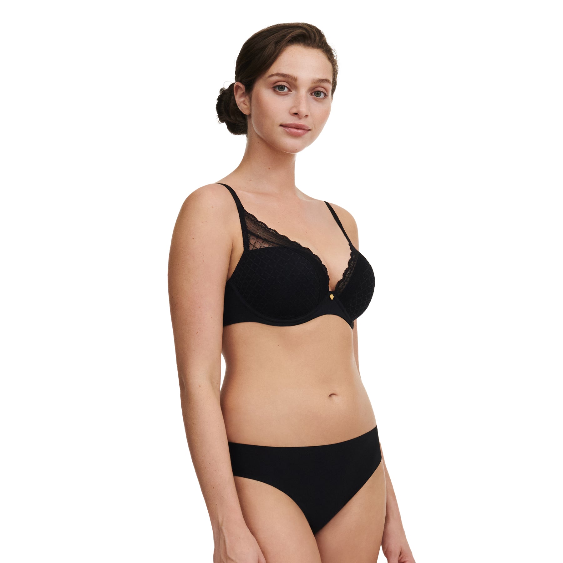 Three-quarter view of model wearing black plunge bra with lace trim and matching black brief.