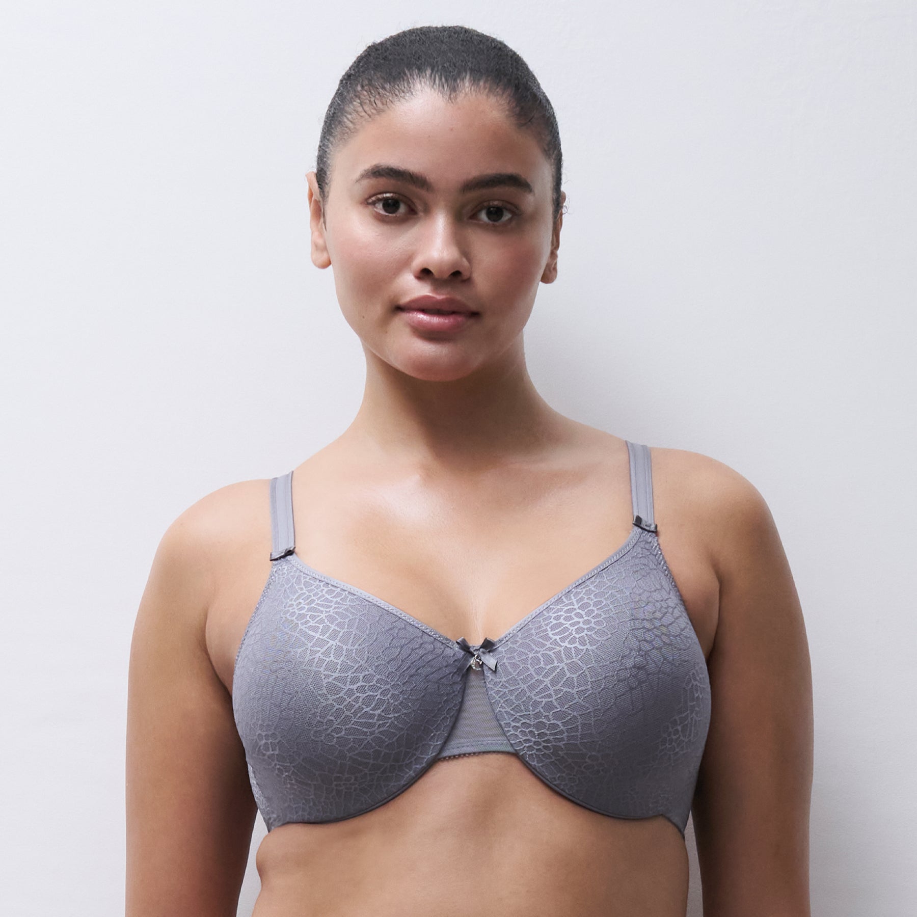 Model wearing Chantelle C Magnifique underwire minimizer bra in New Smoke Grey with smooth shaping and full coverage fit.