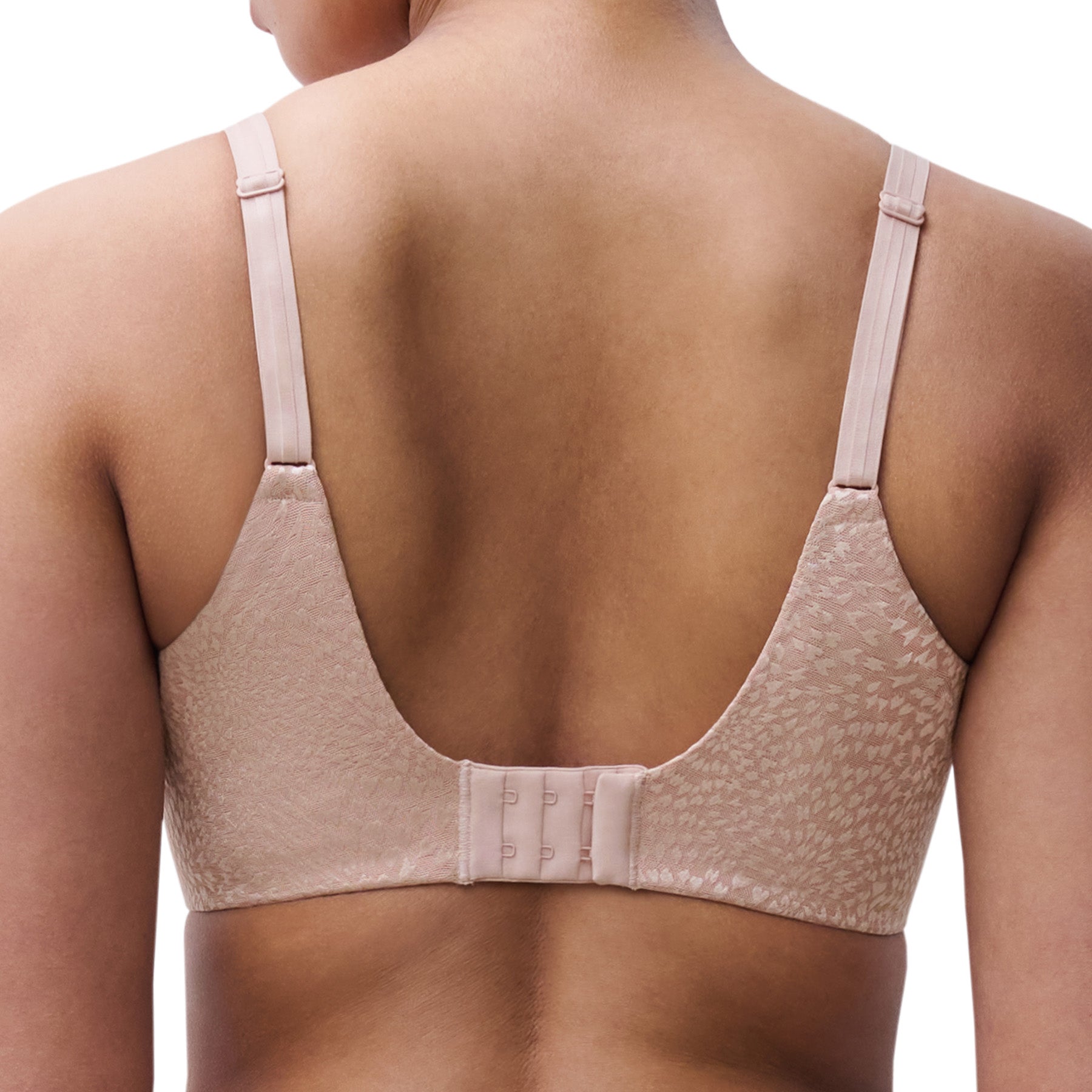 Back view of soft pink minimizer bra showing smooth back band and triple hook closure.