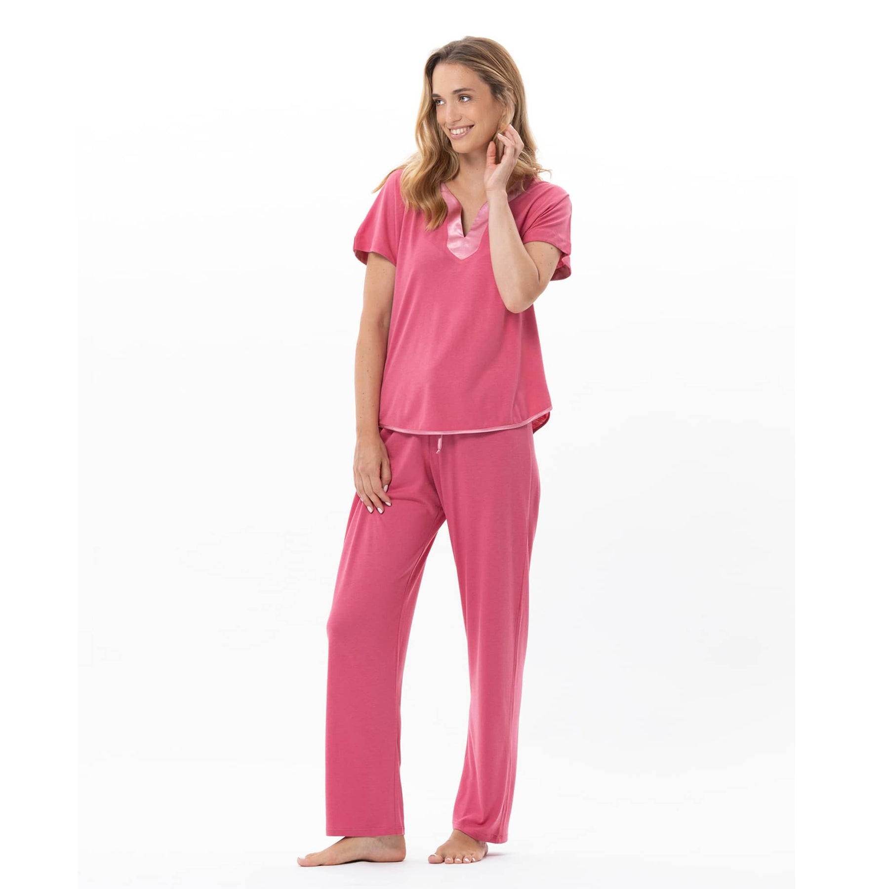 Model wearing fraise pink pyjama set with satin neckline detail and wide-leg pants – style C223APY.