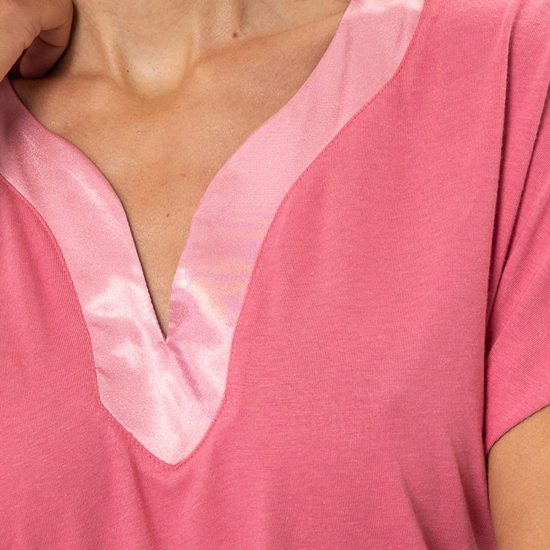 Detail of satin-trimmed V-neckline on fraise pink cotton nightgown