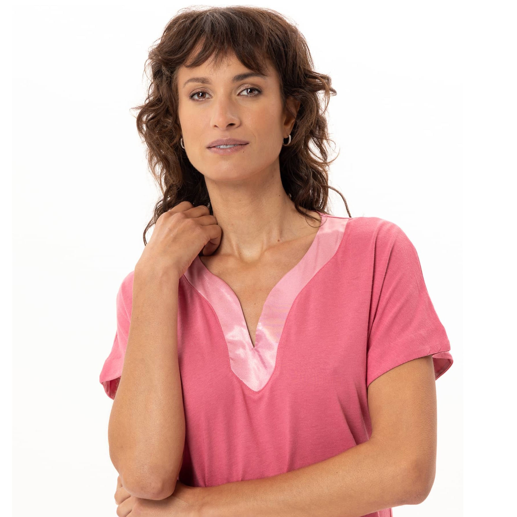 Close-up portrait of model wearing fraise pink sleepwear dress with satin neckline detail