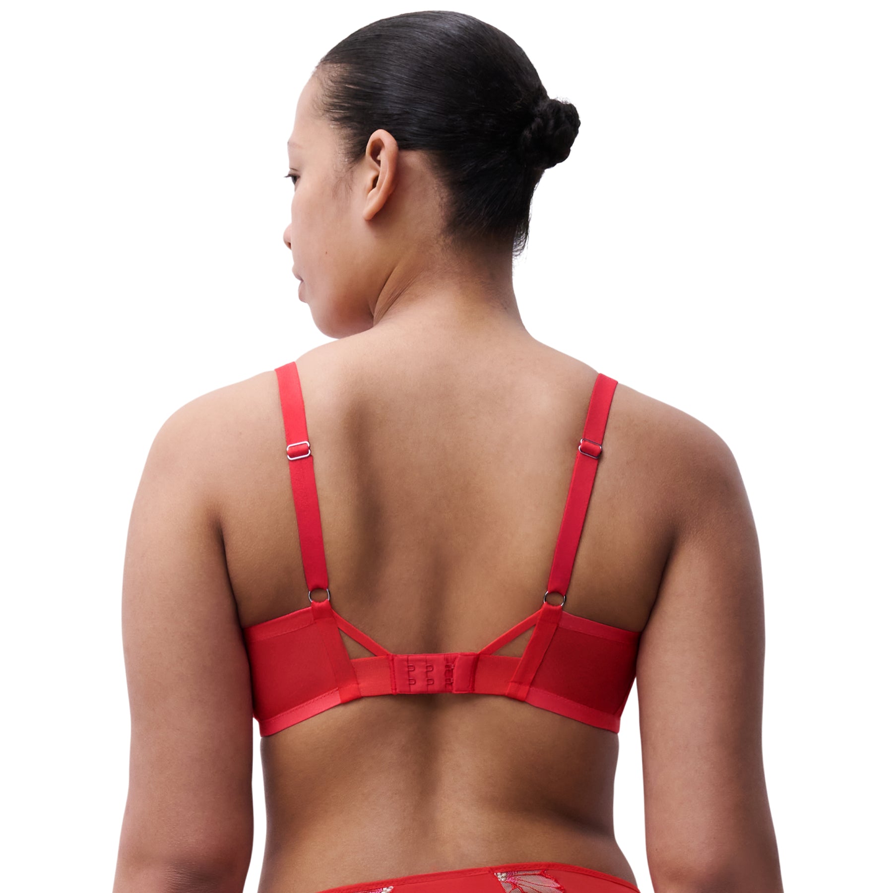 Red bra worn by a model on a white background