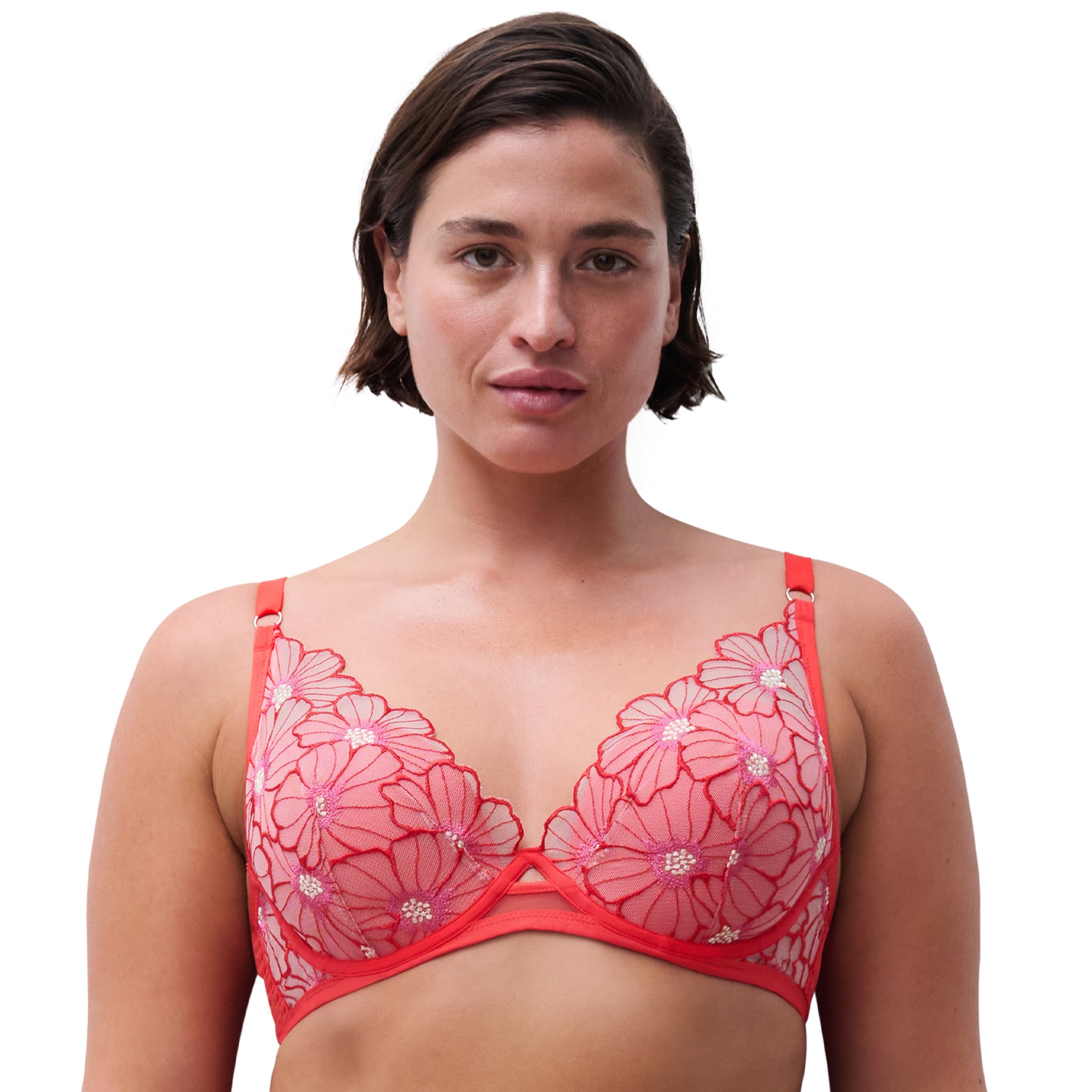 Woman wearing a red floral bra against a white background