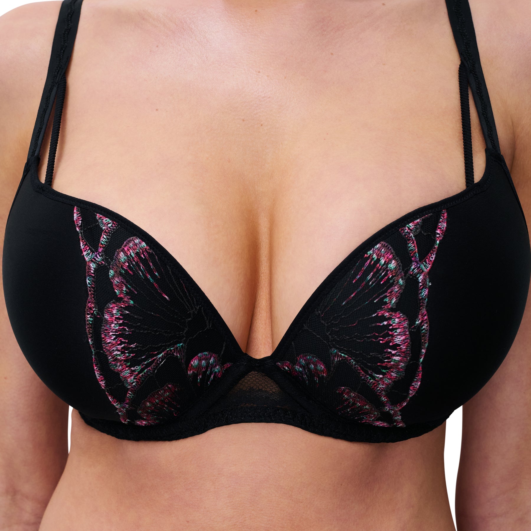 Close-up of black bra with butterfly embroidery, highlighting plunge neckline.