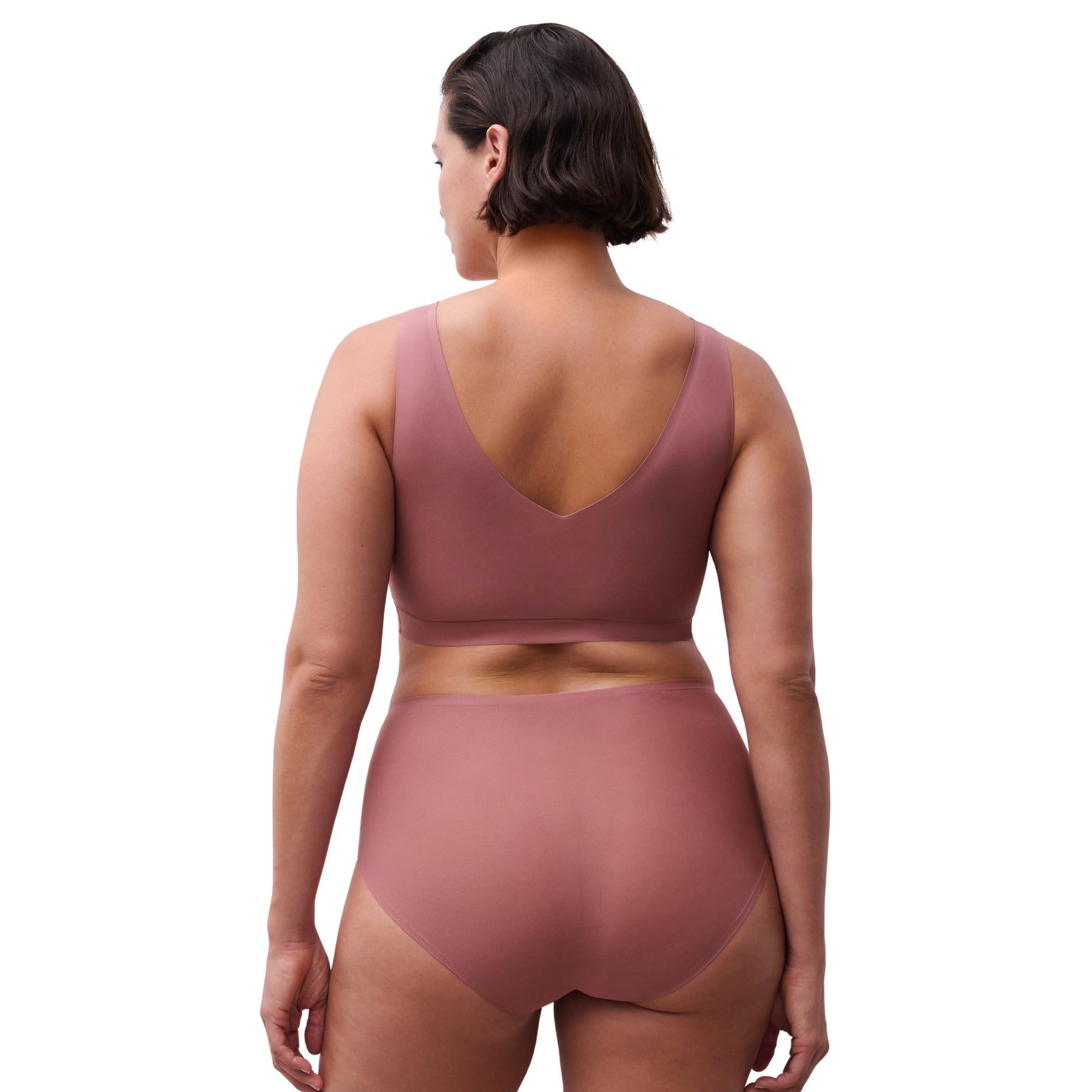 Woman wearing a mauve two-piece set on a white background