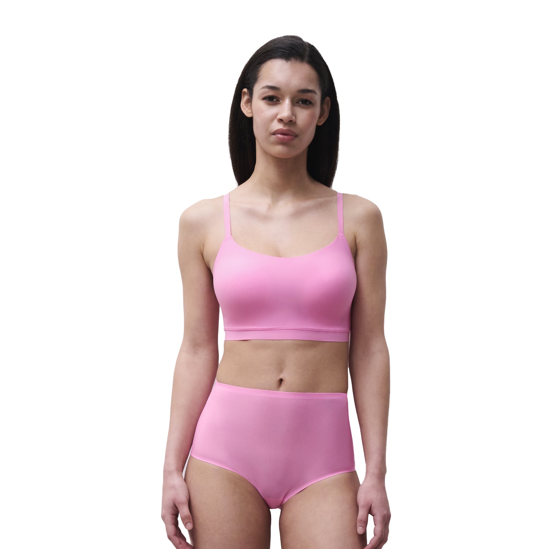 Model wearing a peony pink seamless wireless bra and matching high-waist briefs with a smooth second-skin fit