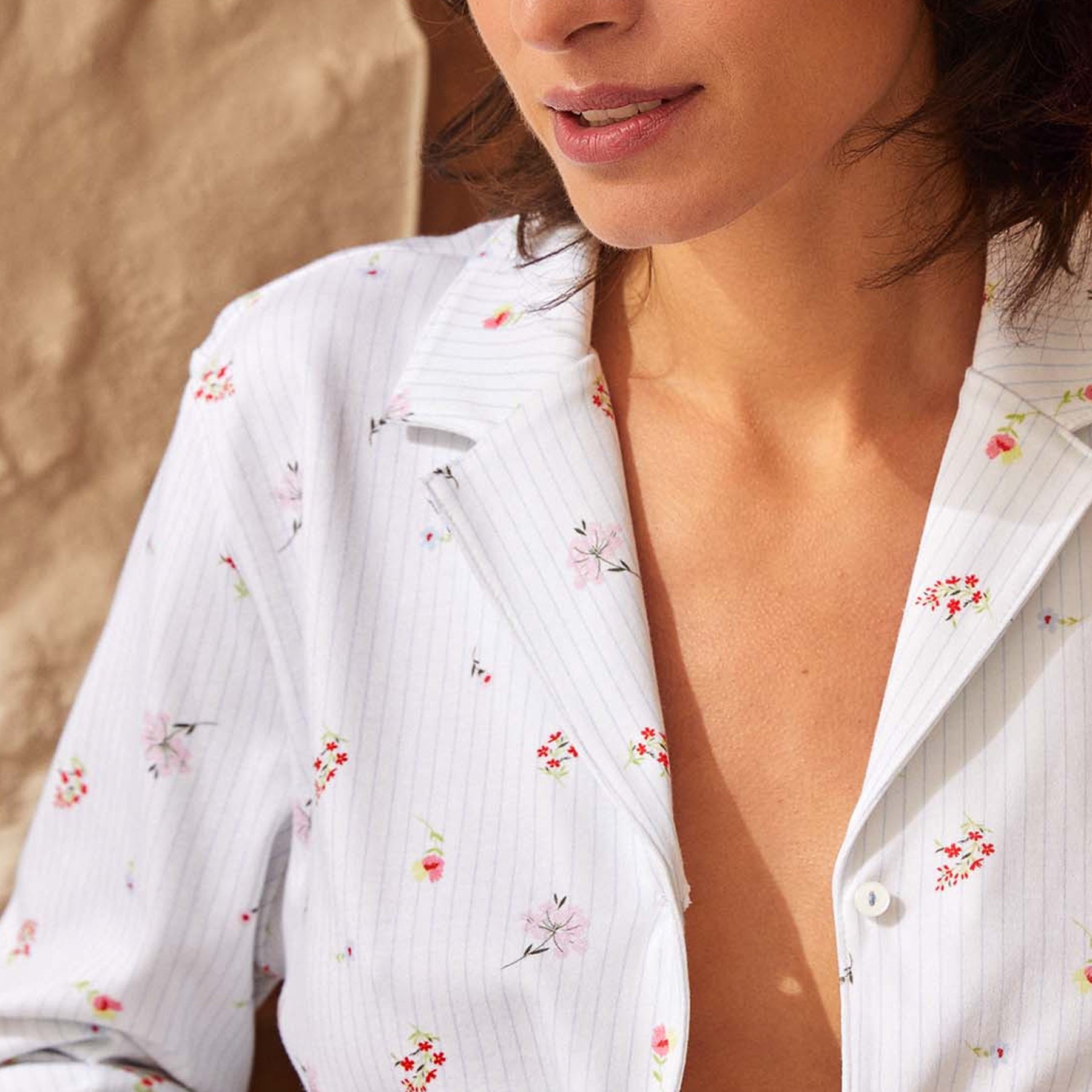 Close-up of the white pajama top showcasing the delicate mini floral print, subtle pinstripes, notched collar, and button-front design.