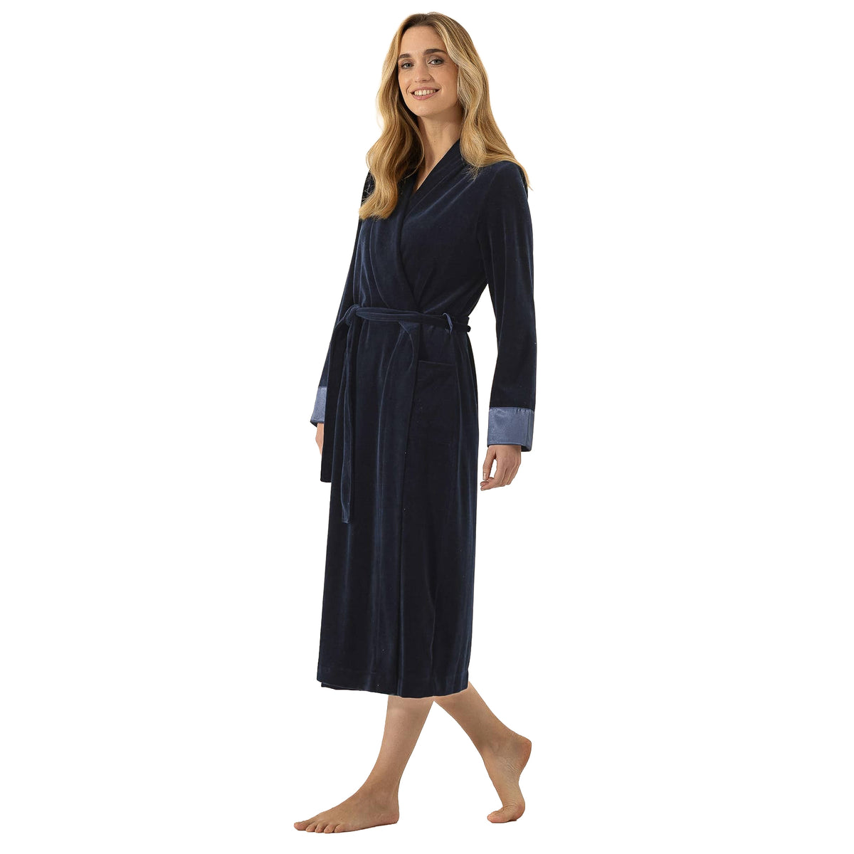 Side view of a long navy velour robe with a wrap front, adjustable tie waist, front pockets, and contrasting satin cuffs.