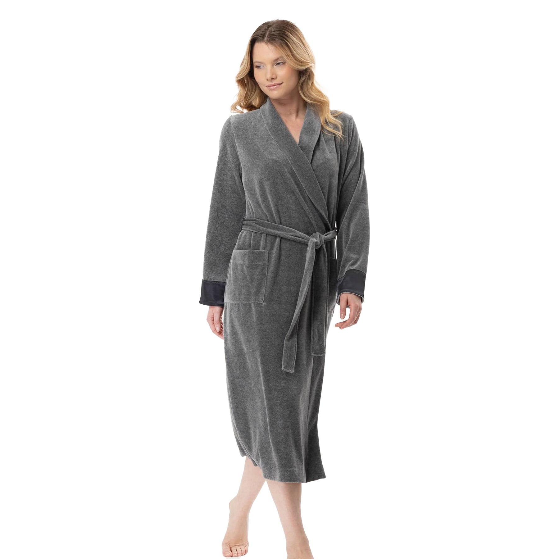 Woman walking in grey velour robe tied at the waist, showing front pockets and wrap design.
