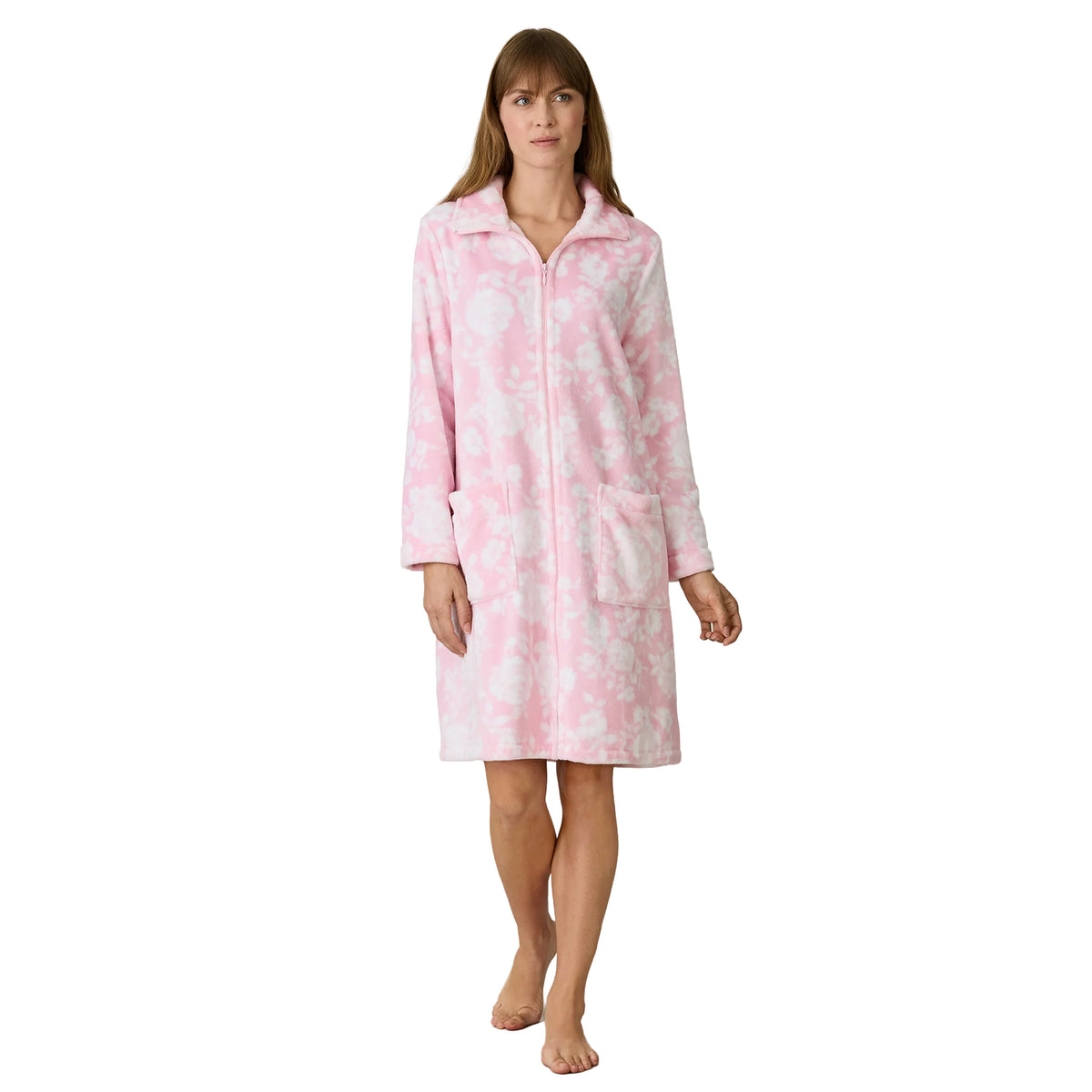 Woman wearing a Carole Hochman blush pink fleece zip robe with a white floral print, fold-over collar, long sleeves and two front pockets.
