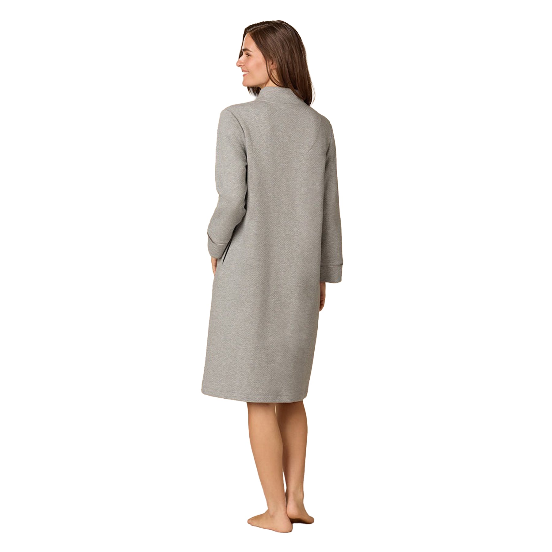 Woman wearing a gray long-sleeve dress on a white background