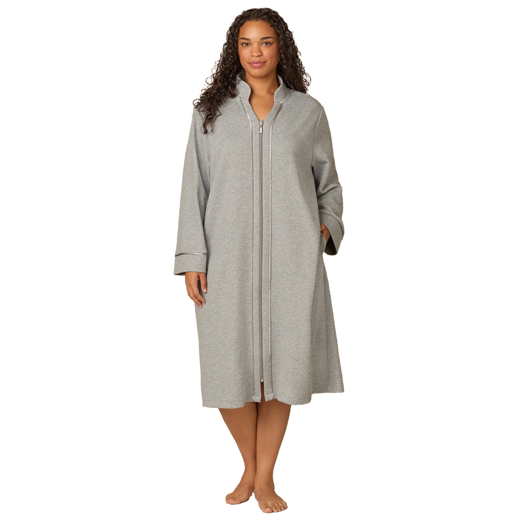 Woman wearing a gray zip-up robe on a white background
