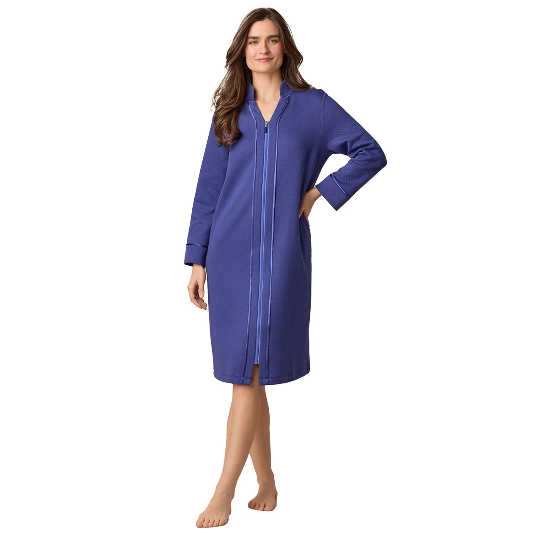 Woman wearing a blue zip-up nightshirt on a white background