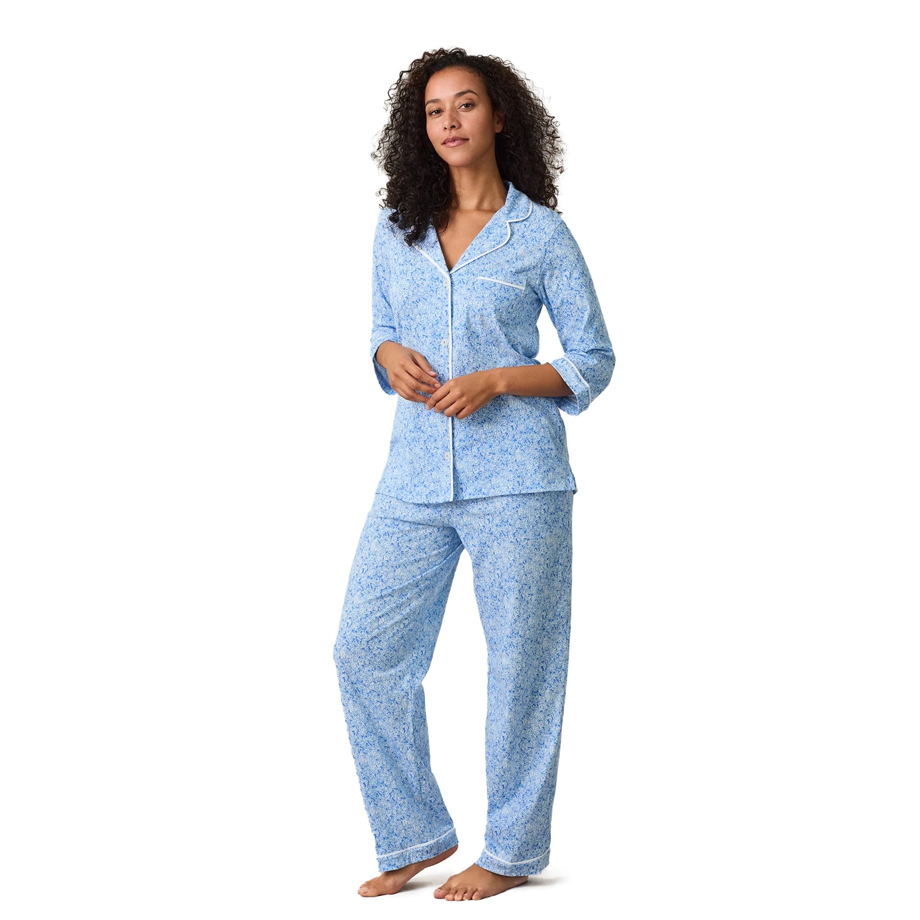 Blue floral print pyjama set with button-front shirt, white piping trim and relaxed pants, front view.