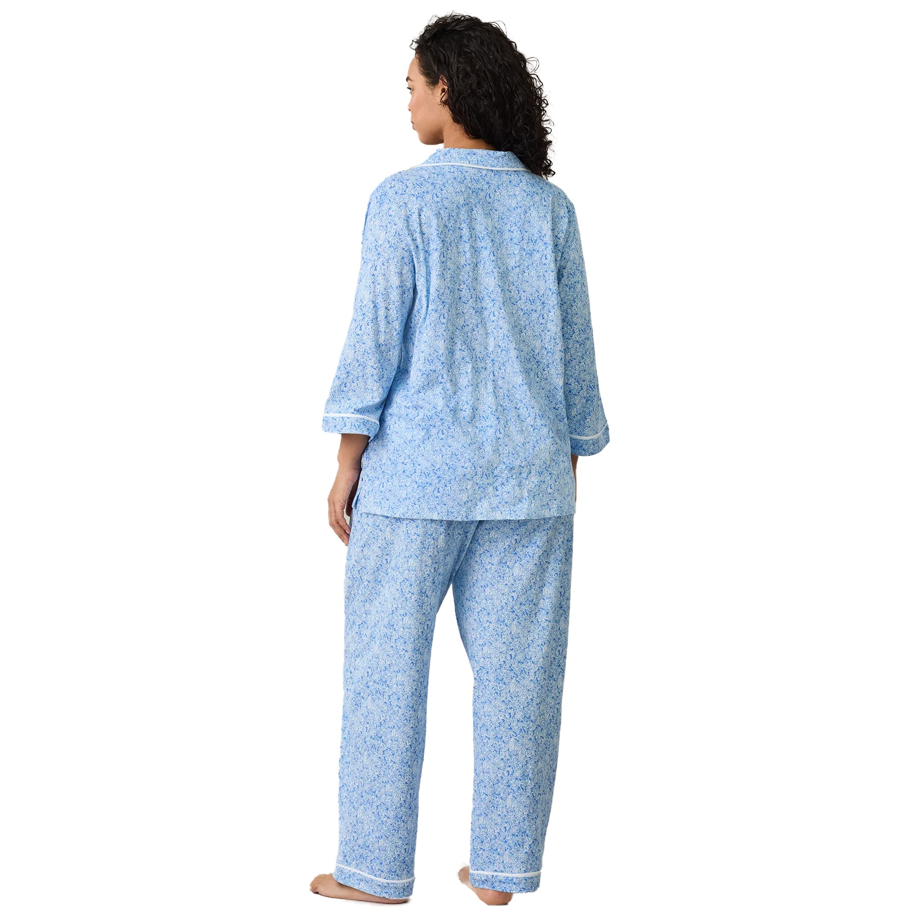 Women’s floral sleepwear set in soft blue print with button-down shirt and full-length pants, back view.
