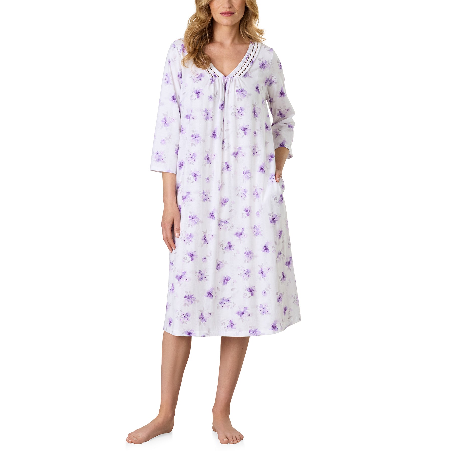 Close-up of the Carole Hochman floral long sleeve nightgown featuring a soft white background with lavender blossoms, a V-neckline with decorative ladder trim, and a small bow accent.