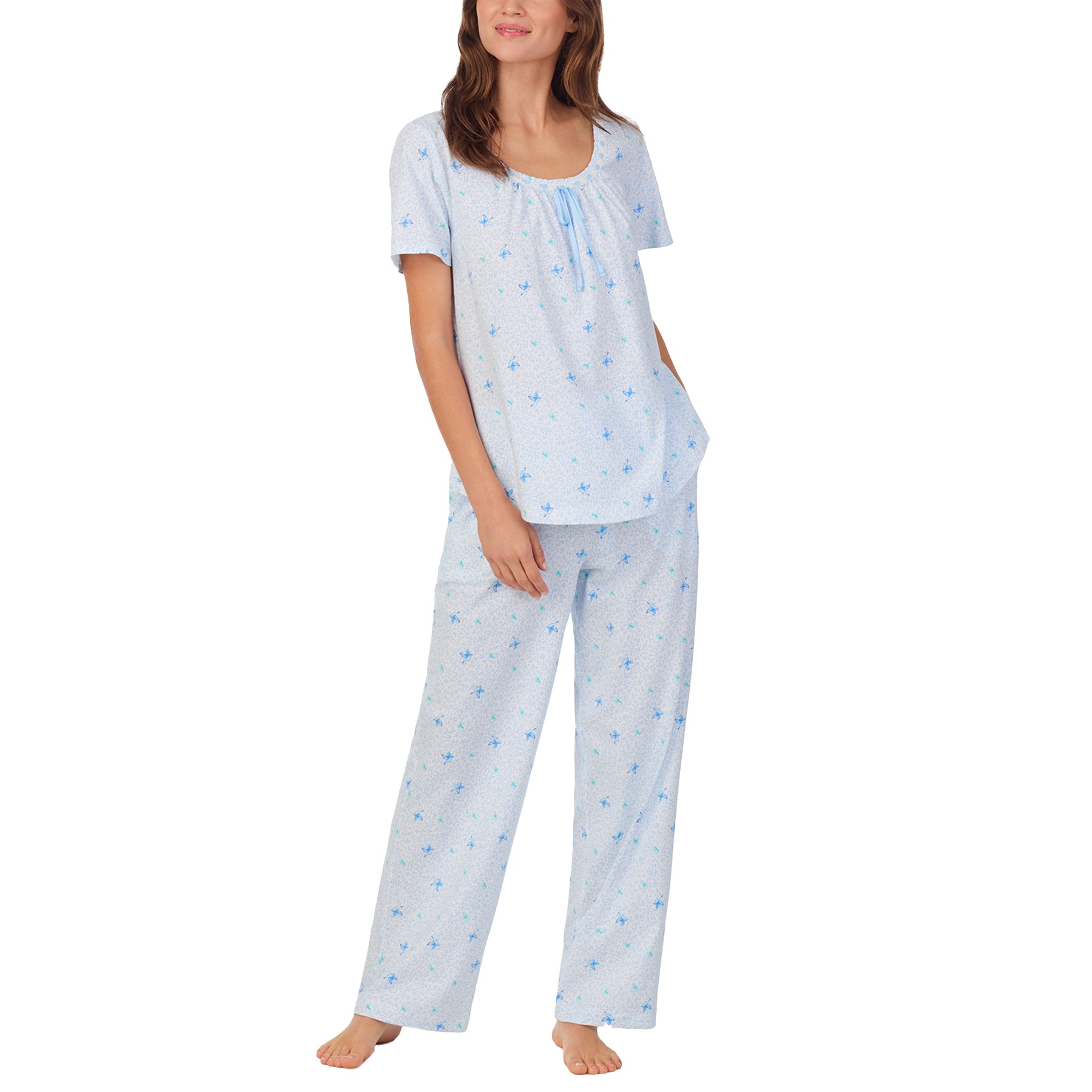 Full-length view of a woman in a matching light blue cotton pajama set with short sleeves and relaxed-fit pants.
