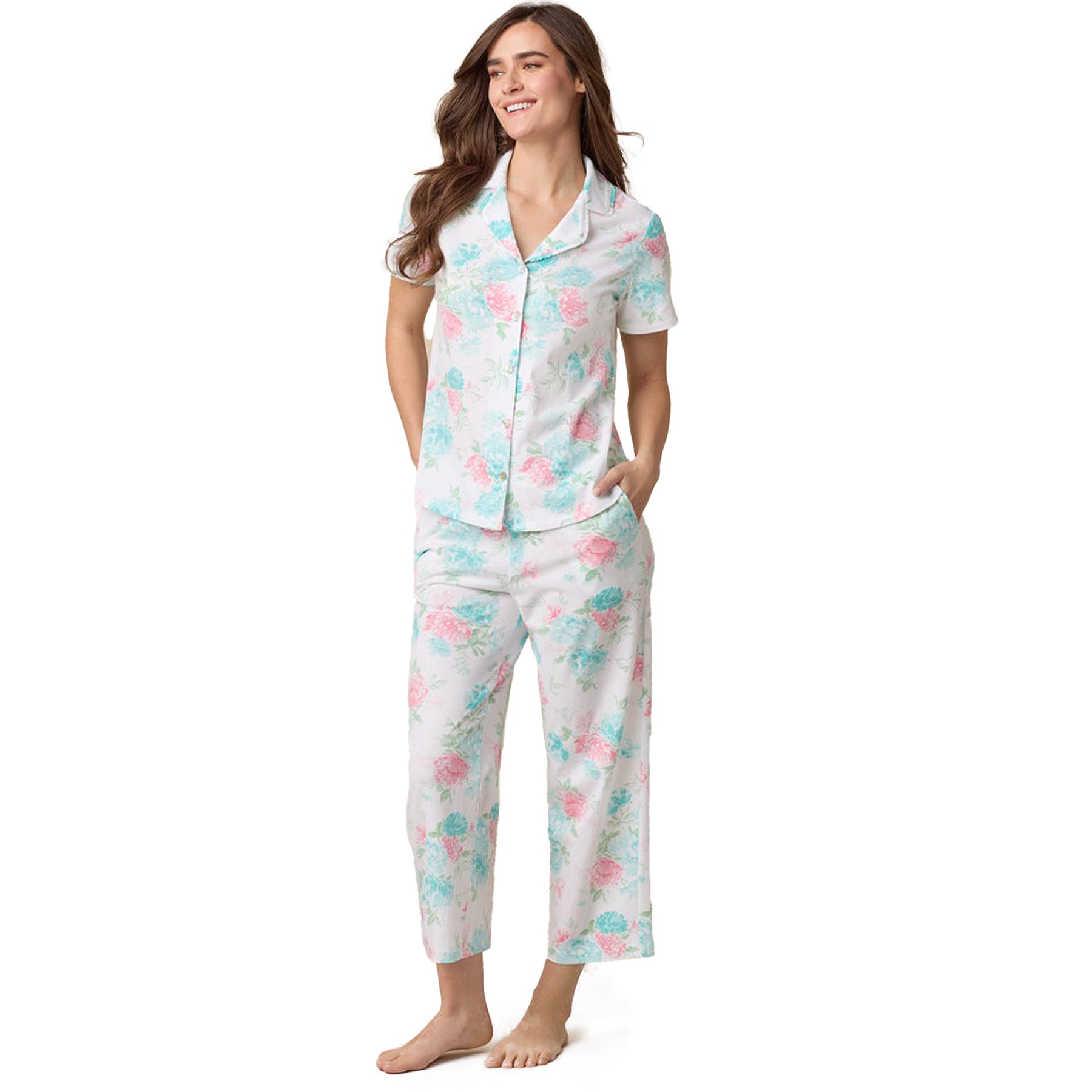 Smiling model in soft pastel floral pyjama set featuring relaxed fit and classic collar - front standing pose.