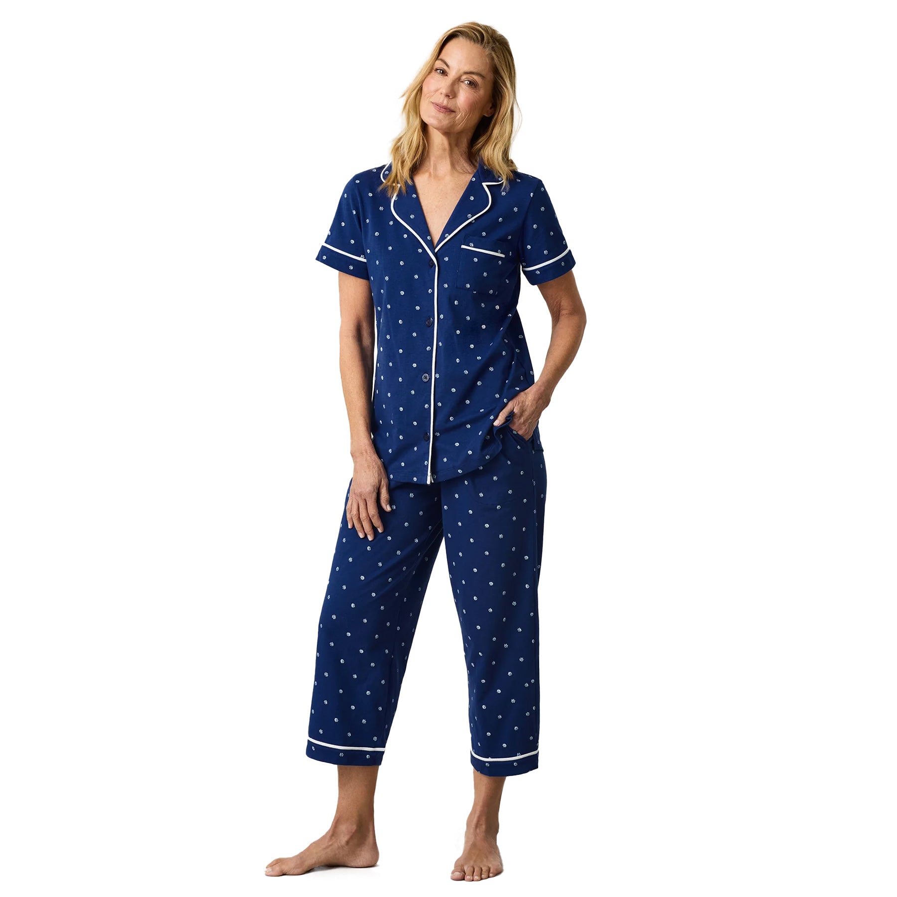 Women’s navy blue short sleeve pyjama set with ditsy floral print, button-front shirt and cropped pants.