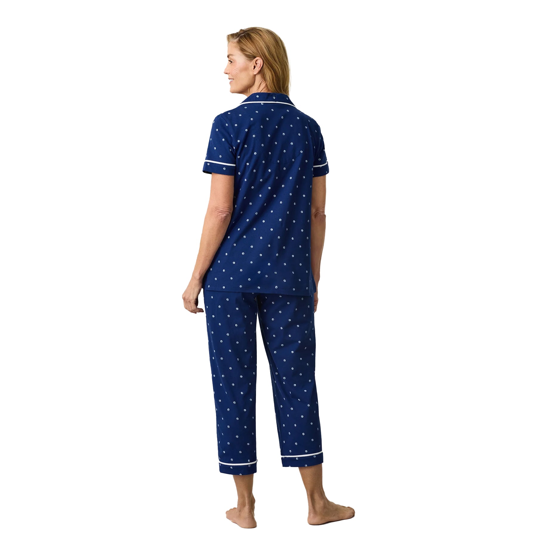 Navy blue floral print pyjama set with short sleeve top and cropped pants, back view.